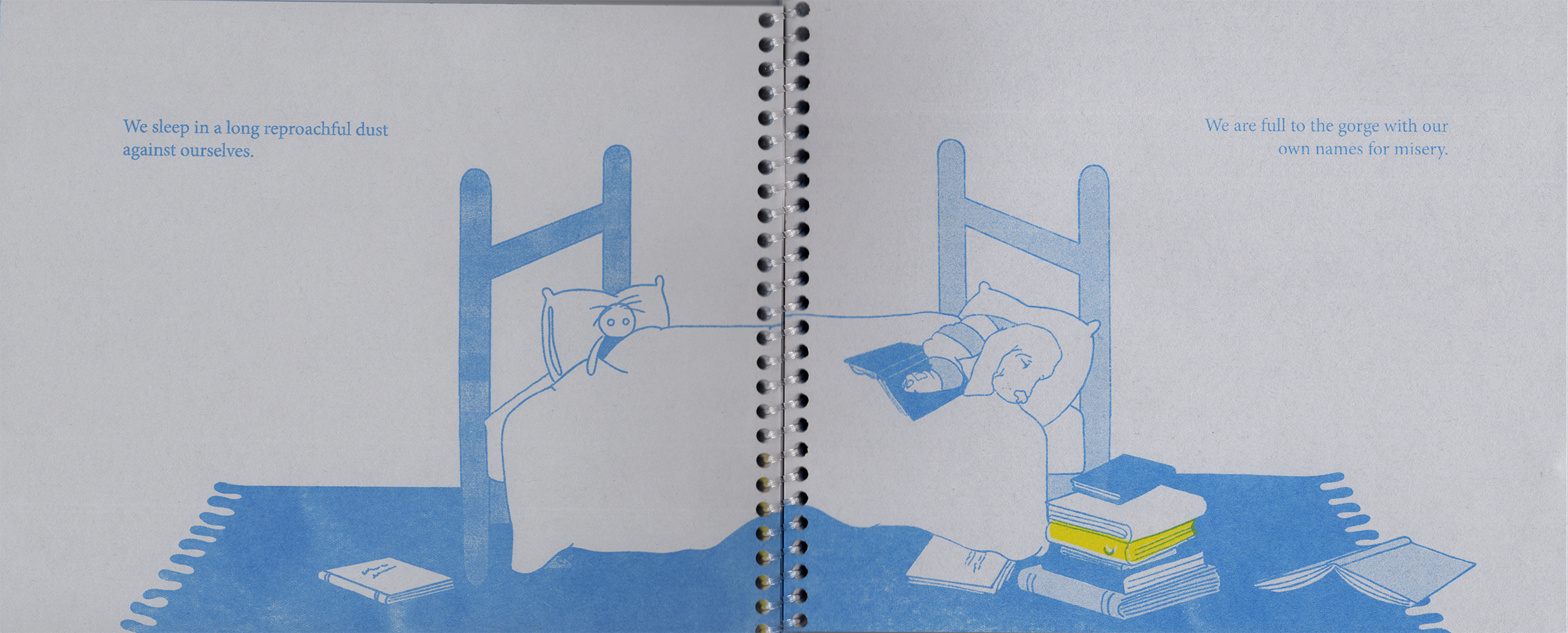 An open spread of the zine, printed on gray paper with a clear coil binding at the center. Across the spread is an illustration of a bed with a sleeping dog in striped pajamas clutching an opened book in one paw. At the other end, a doll is tucked in leaning again a pillow. A rug is placed under the bed and various books are stacked and spread out on it, including one yellow book with a moon sliver on the spine. The text is placed in the two upper corners of each page.