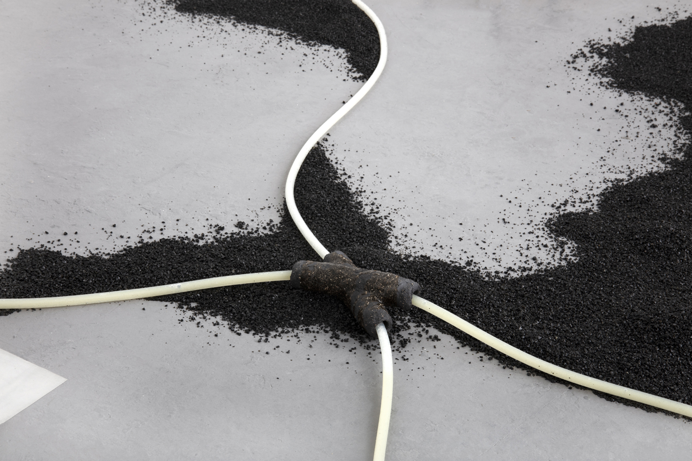 The propensity of things, 2019, [various dimensions], Slade Interim Exhibition  Whey protein powder, silicone tubing, volcanic sand, vulcan black grogged ceramic 