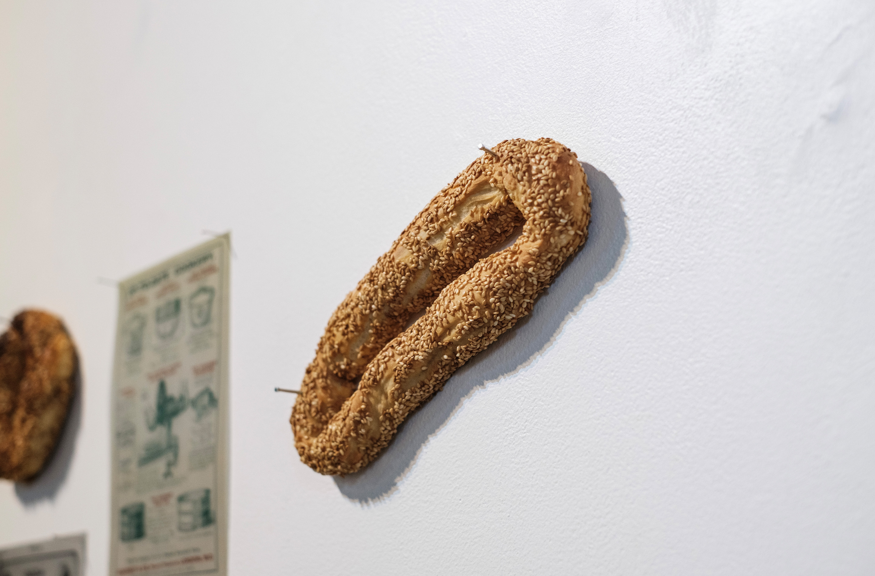 The event, is constructed in a nexus of mediums. In bread, bodies, video, text and dismembered table. Photograph by Temitope Adesina