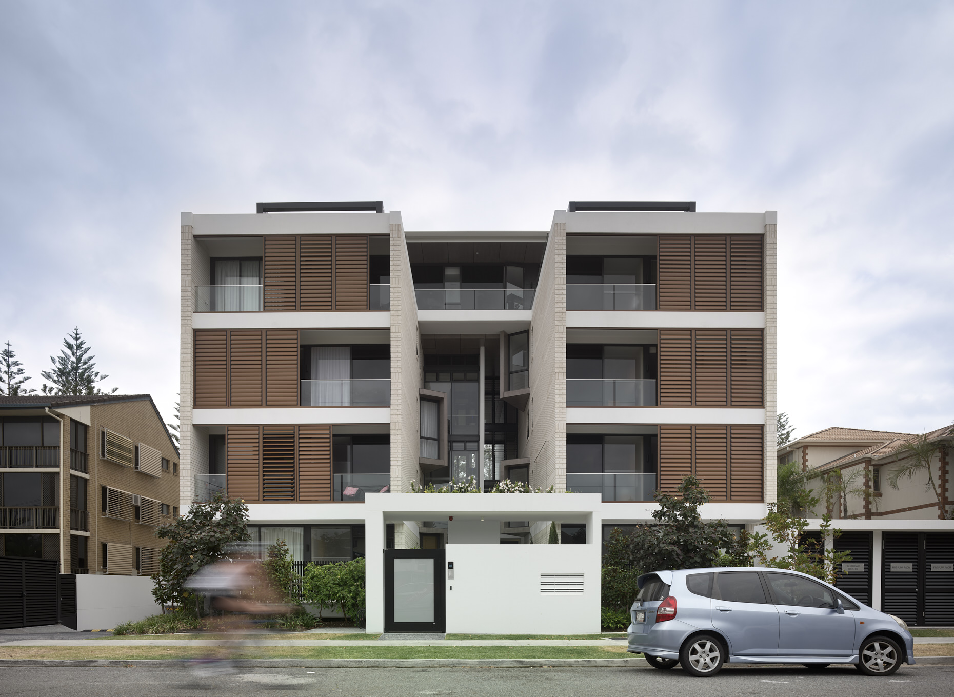 Street view of boutique contemporary apartment with moveable timber screening.