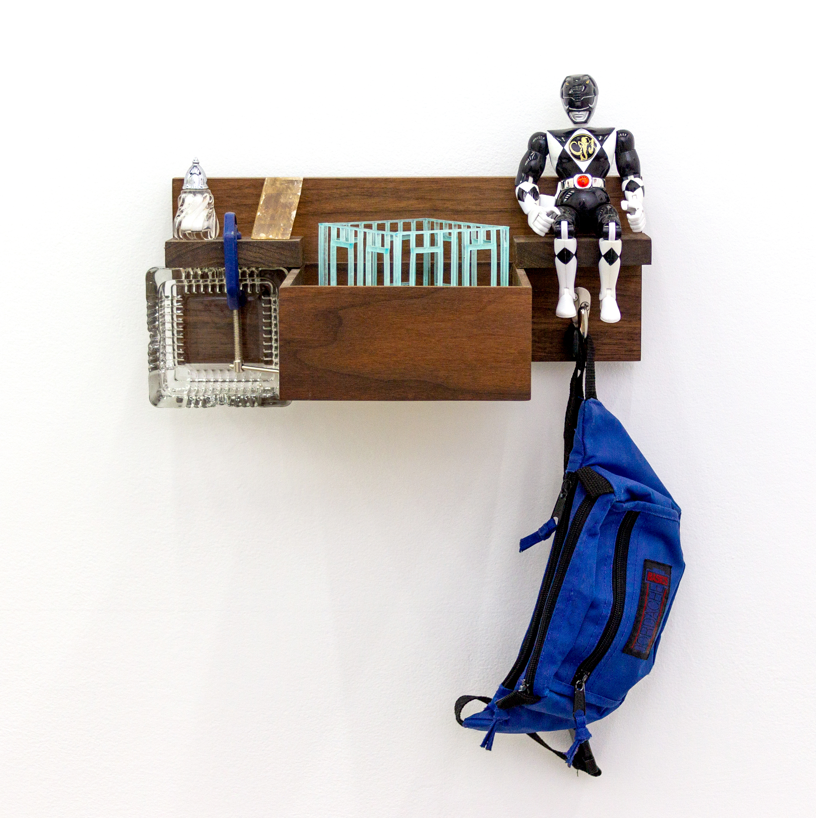 It Exudes Its Shell, 2023, 21" x 15" x 8". Wood, danish oil, photopolymer resin, polystyrene foam, acrylic paint, faux grass, faux dirt, pva adhesive, glass ashtray, c-clamp, yellow optical calcite, salt shaker, iodized salt, action figure, fanny pack, hardware