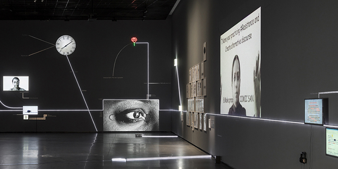 A panorama shot of Mithu Sen's exhibitions featuring multiple display screens of human features