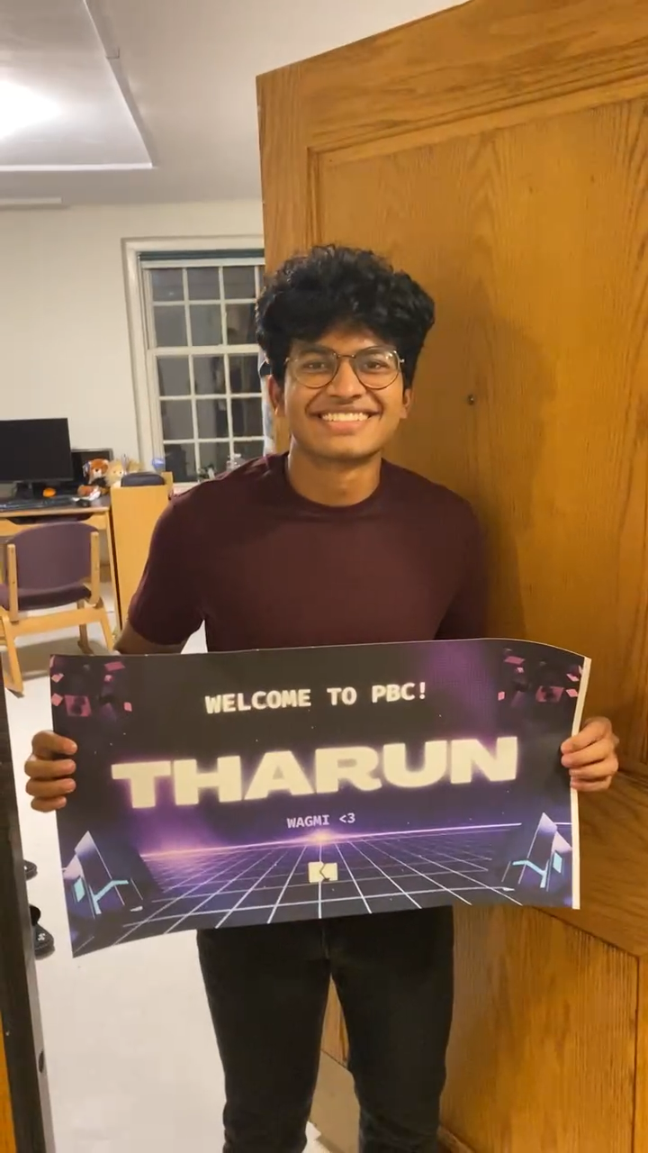 Tharun holding a sign that welcomes him to PBC