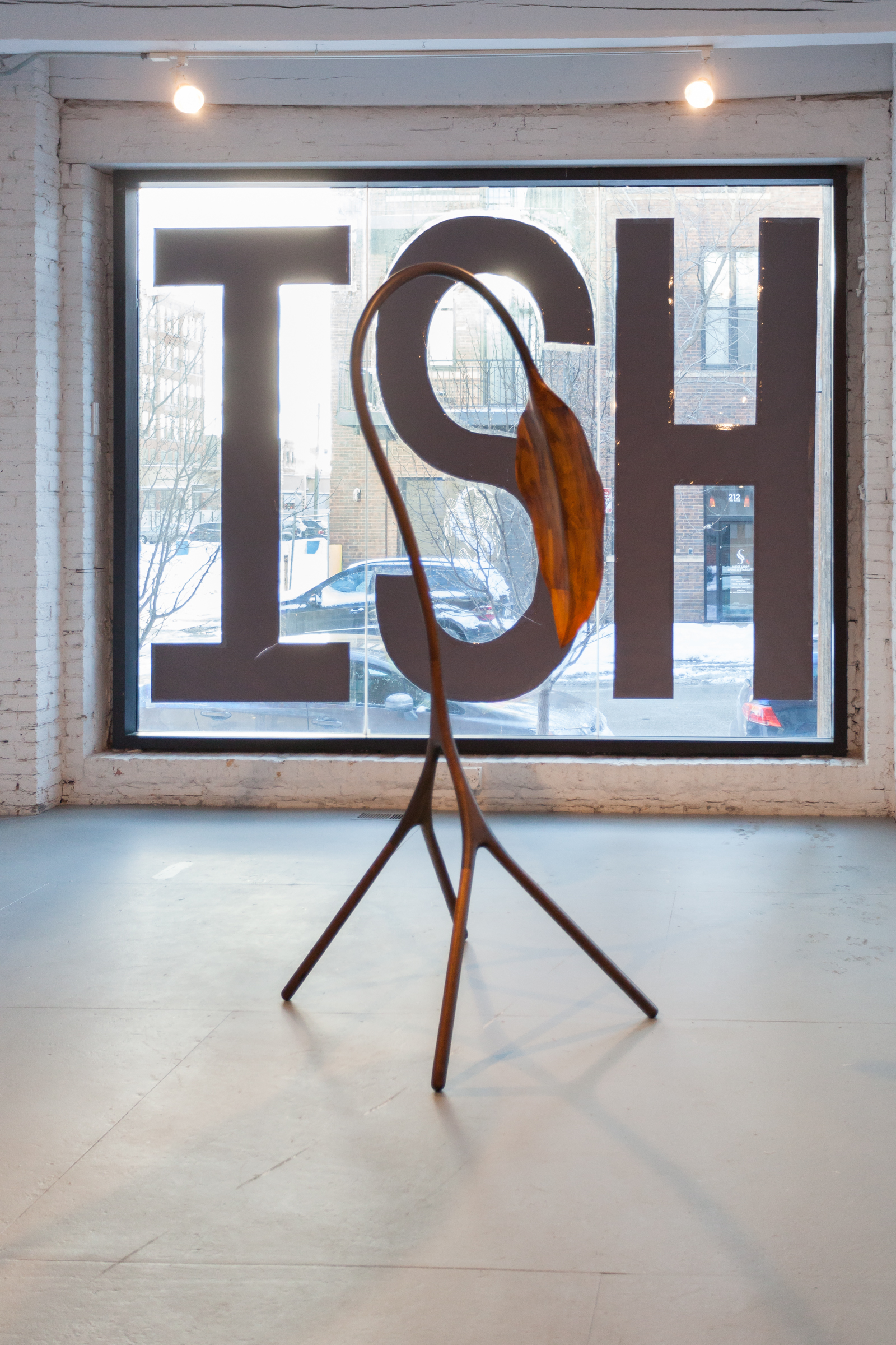 4/5 — SELFISH.  Site-specific installation created for the exhibition Hiding in Plain Sight, curated by George William Price at the Chicago Artist Coalition; hand-cut paper, packing tape; text on floor "SELF" measure 144" x 48" each, text on window "ISH" 96" x 48" each) 2017.
