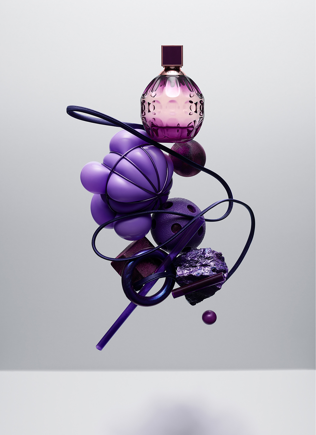 KMA photographer Isabelle Bonjean shoots photograph of floating purple perfume bottle for Faux Q Magazine