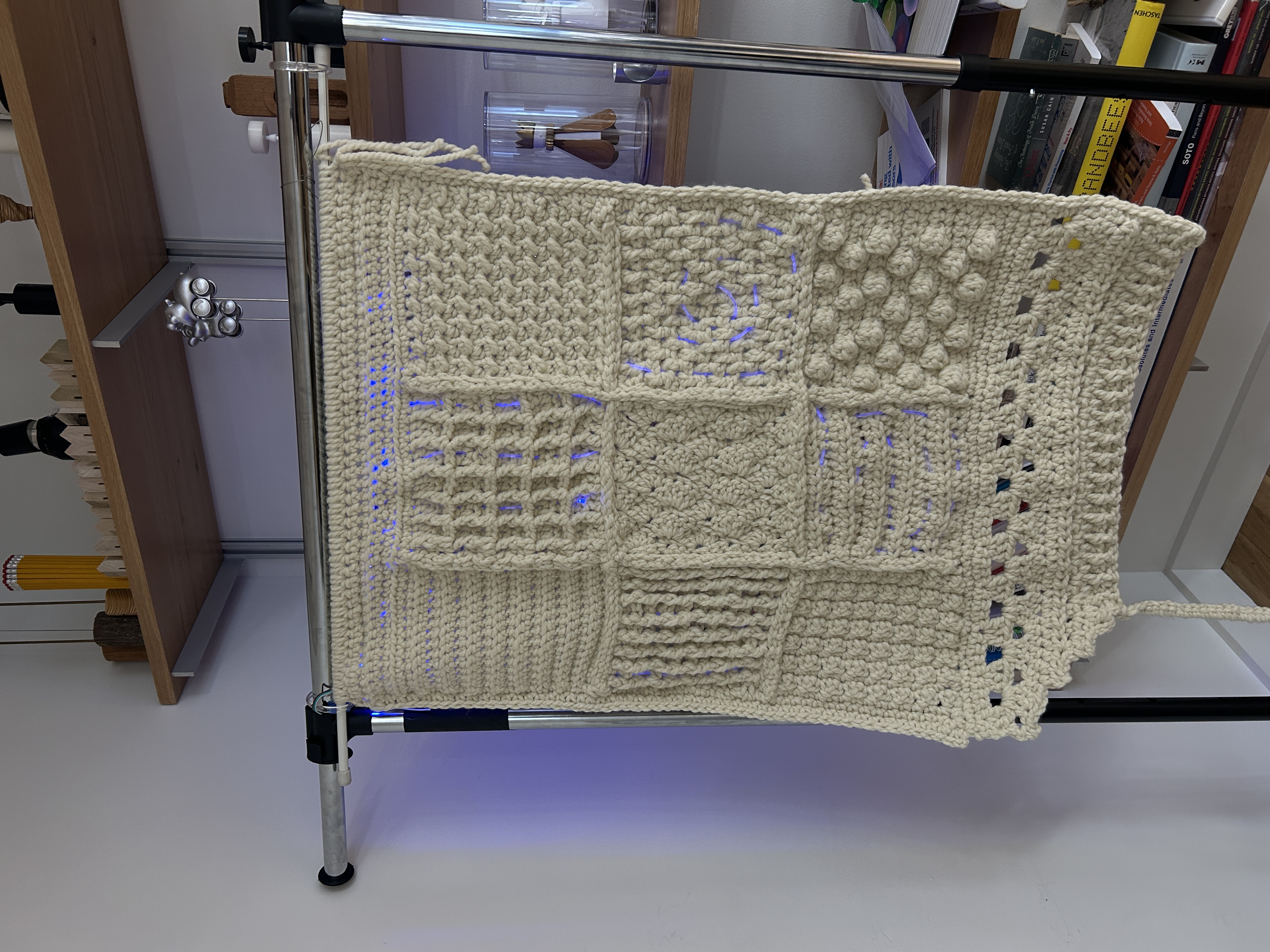 The front of the blanket with fiber optic cables woven through it