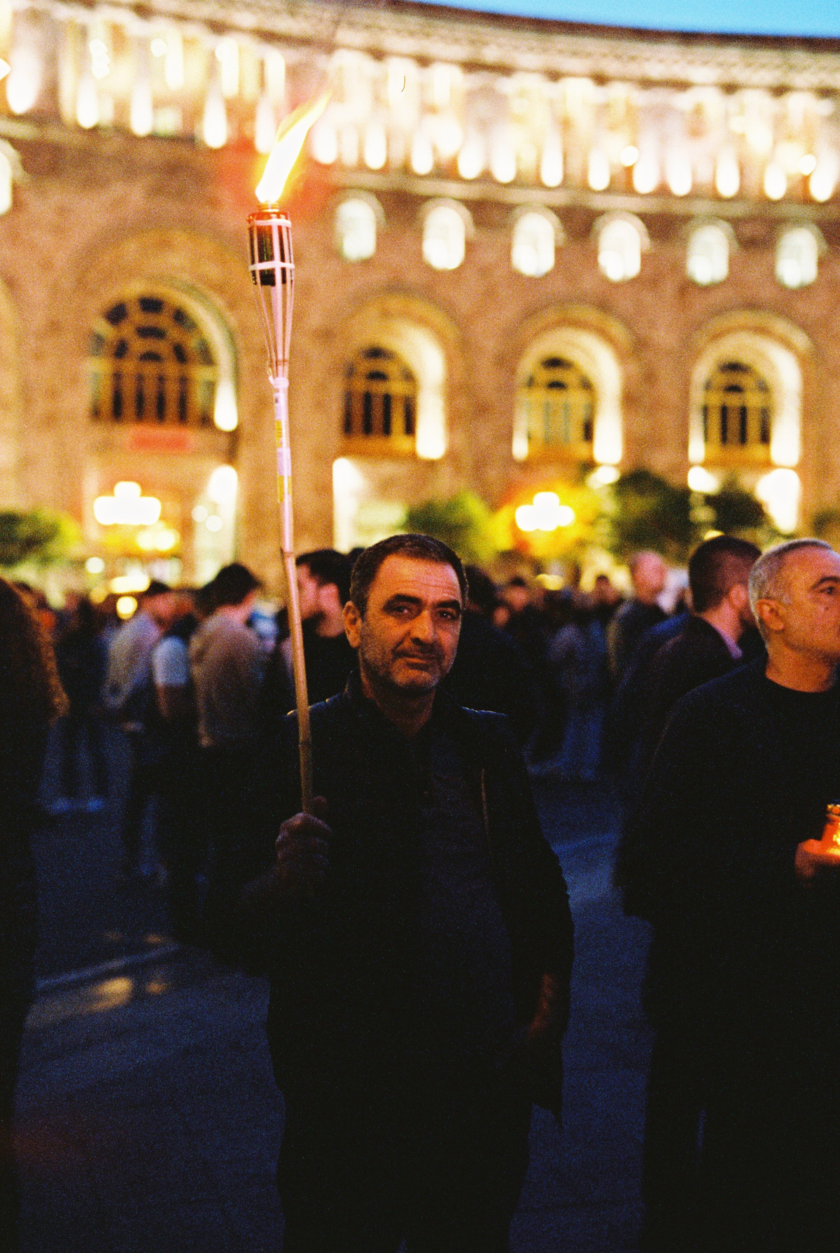 An air of hesitation surrounded those with tiki torches when asked to be photographed. Thankfully, this person cut through that. Cinestill 800T.
