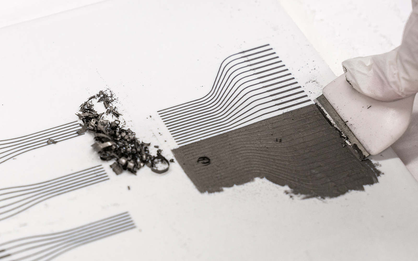 Scraping excess ink off a ceramic tile (smartphone touch screen dock)