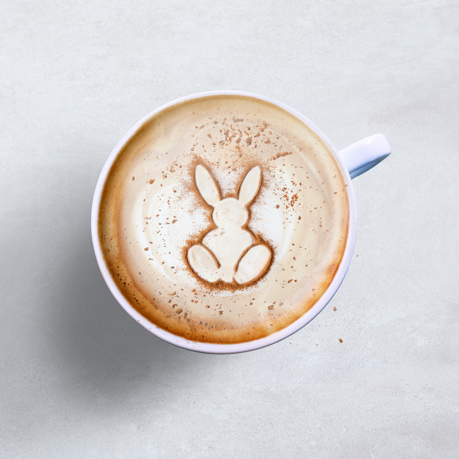 Hot beverage topped with bunny-shaped cinnamon powder