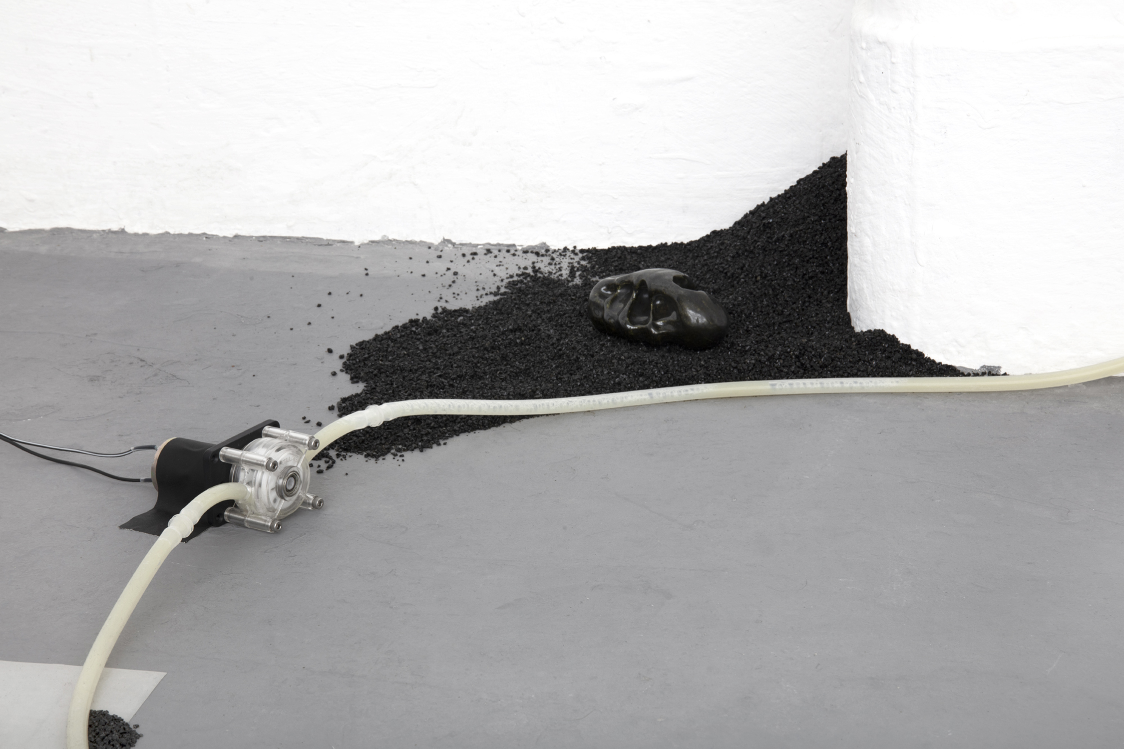 The propensity of things, 2019, [various dimensions], Slade Interim Exhibition  Whey protein powder, silicone tubing, peristaltic pump, volcanic sand,   black mirror glaze on white ceramic 