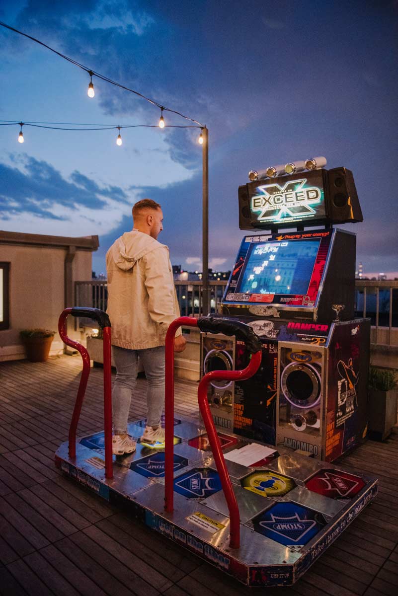 Person playing on Dance Dance Revolution machine