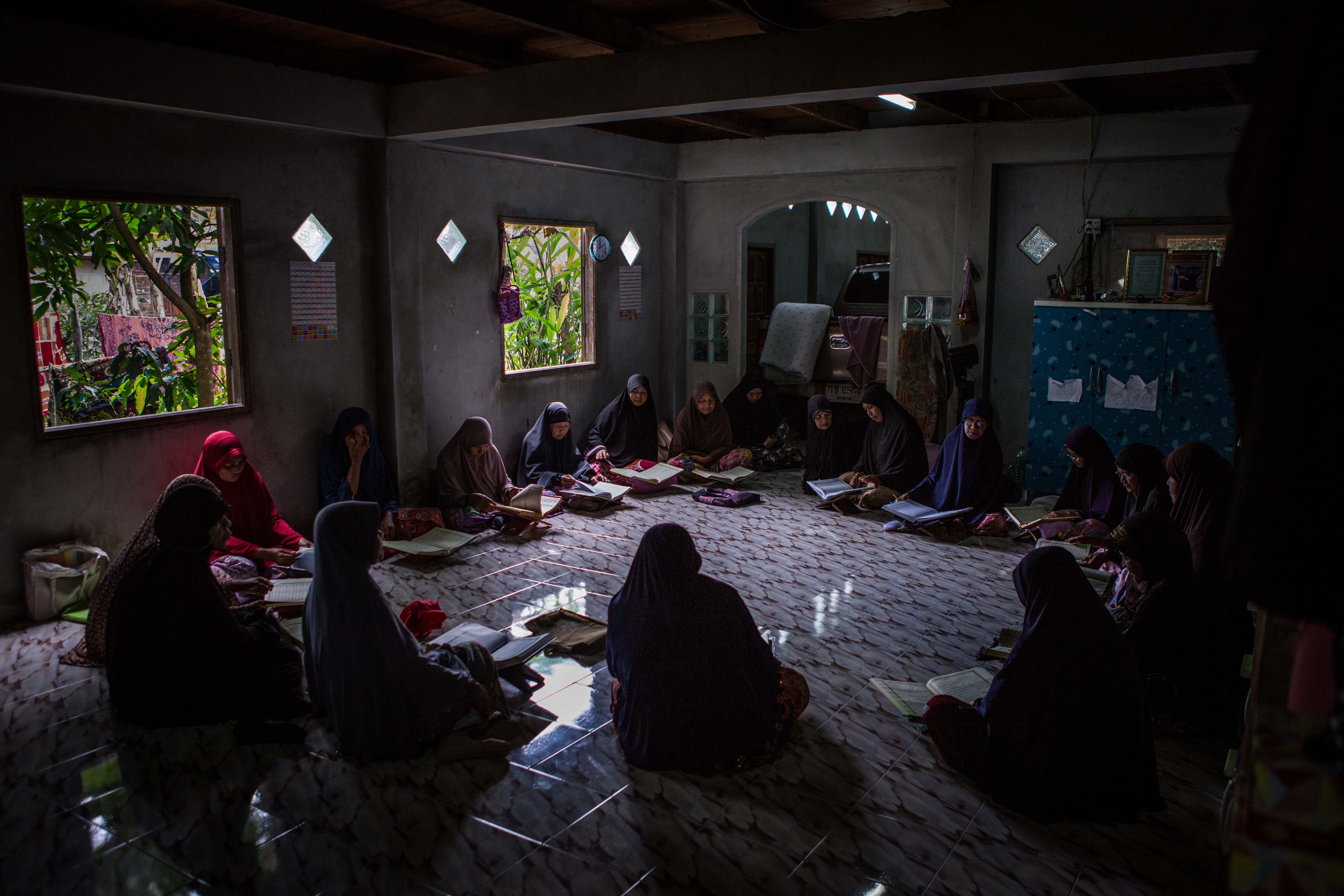 A women’s group during their daily study of Islamic holy books, at a community center in Ku Ching Lue Pah village, Narathiwat province, Thailand on November 15, 2017. Villagers here are frequently caught in the crossfire between Thai Army Rangers and insurgent groups, with many being killed or indefinitely detained under suspicion of aiding the nationalist rebels.