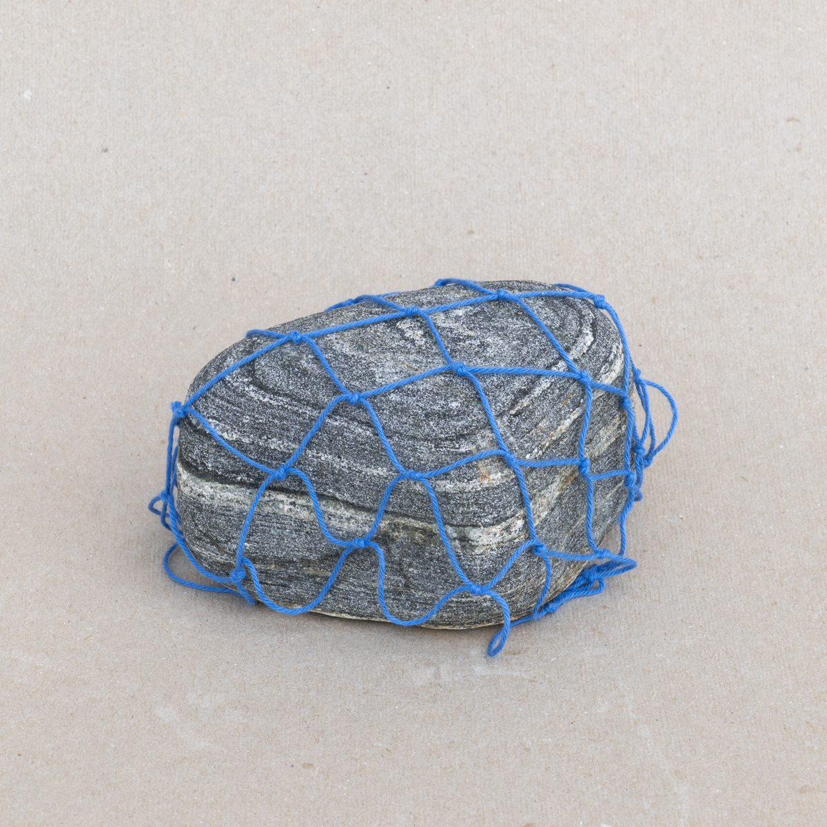 Constrained, 2018, Found rock and cotton warp, 3 x 5.25 x 3 inches