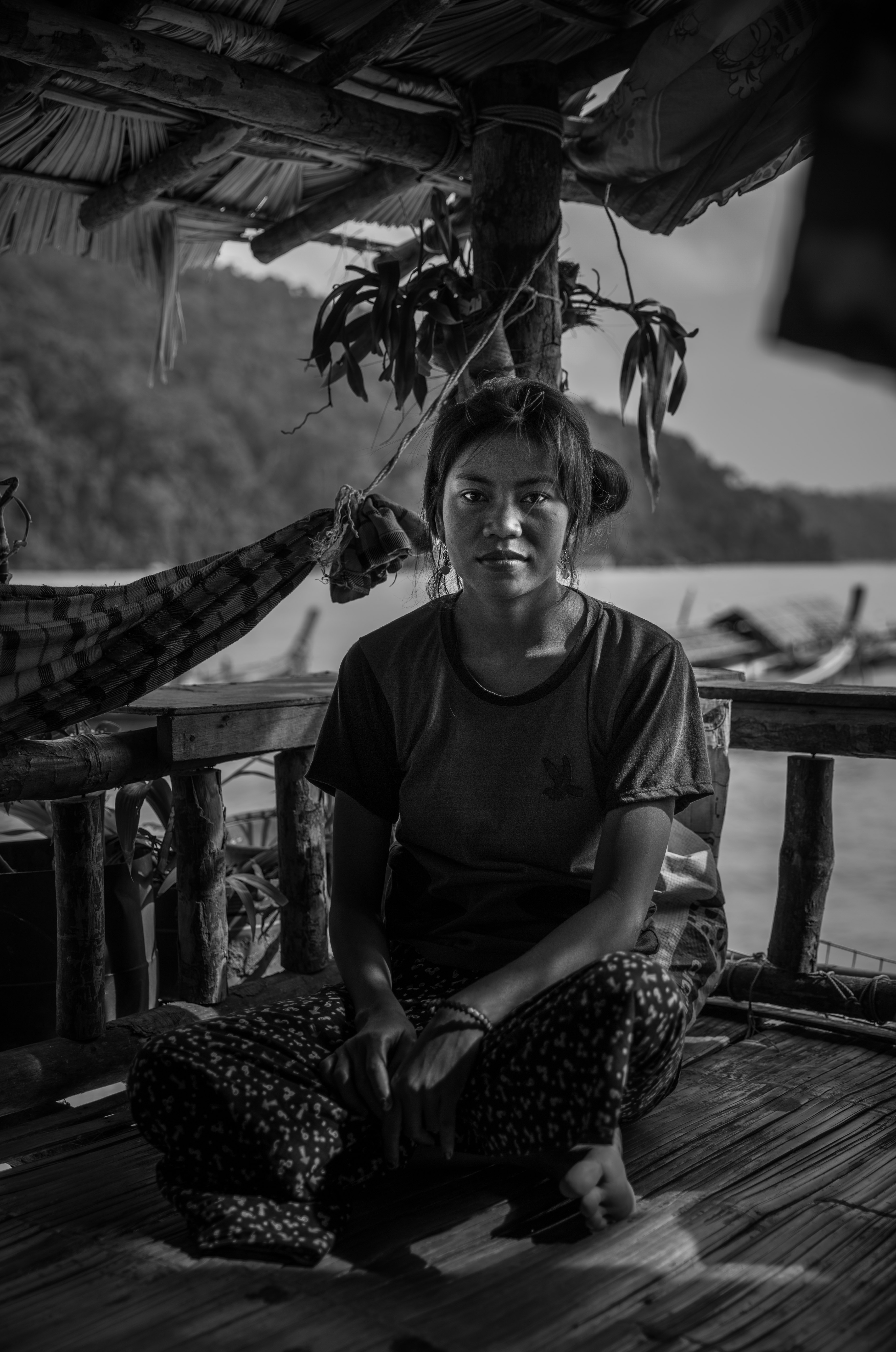 A Moken woman on the front porch of her family home in Bon Yai Bay, South Surin Island, Thailand. January 2, 2017.