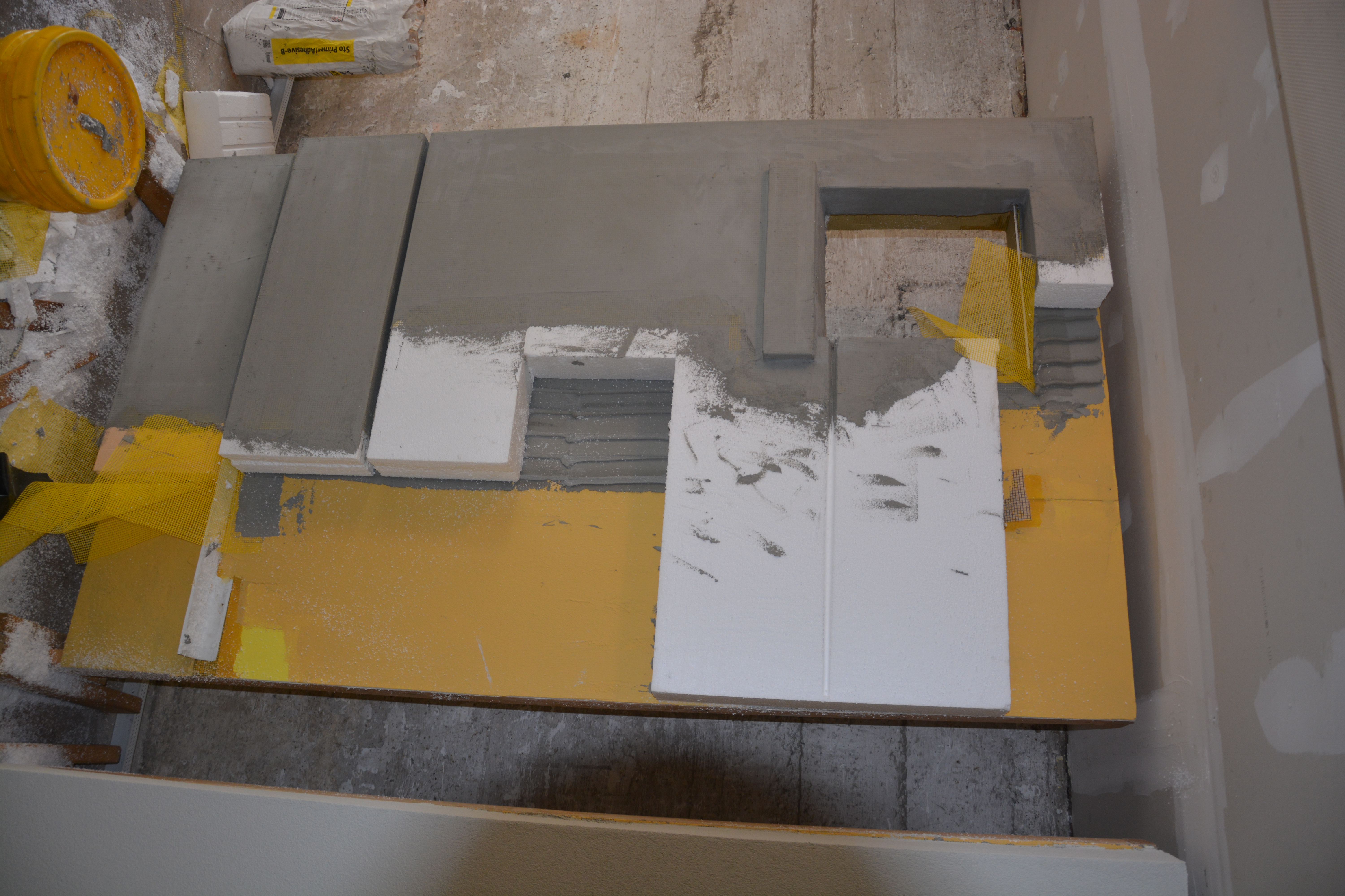 Construction mockup of exterior wall showing air barrier layer, drainage plane, exterior insulation and window opening