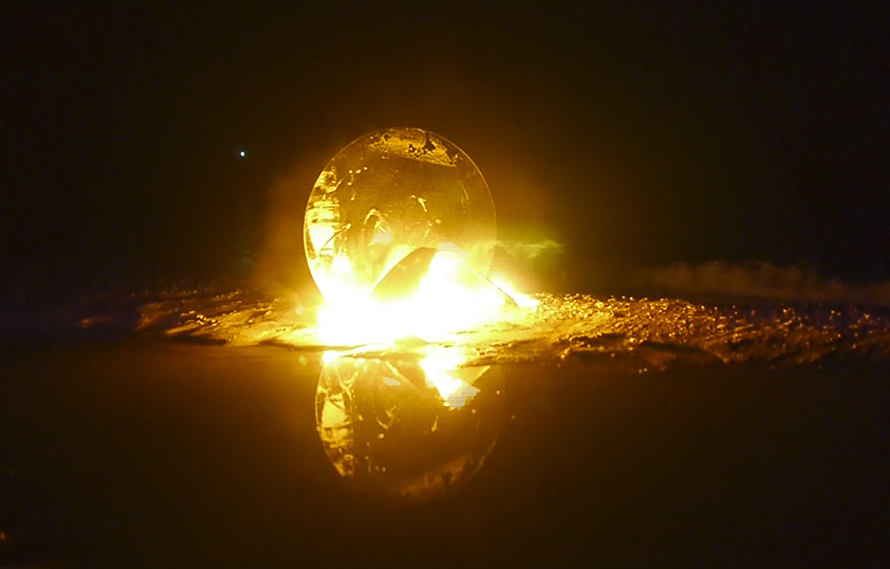 Drop of Sun / 2014 / Circular mirror fragment, intervened and burned as part of an action carried out at midnight on the beach of Chelem, Yucatan. This video piece shows the combustion of a type of Arno Jacobsen ant chair and a circular mirror, planted next to a mirror of water. This piece articulates the end of the Ghost Variations project and is conceptually and symbolically linked to the beginning of the project, titled The Midnight Sun / Video / Duration: 2:30 min.