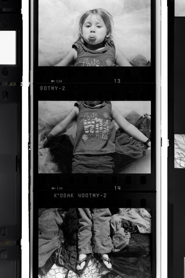 Triptych of a toddler playfully sticking her tongue out, divided into three panels: head, torso, and legs. A charming and defiant yet innocent expression captured in a dynamic and engaging composition.