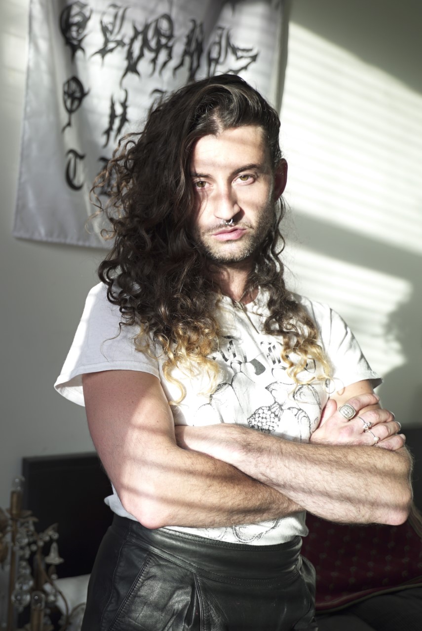 Jake Treacy - curator, arts writer and poet - at home with their art and fashion collection. Photography by Georgia Kartas.