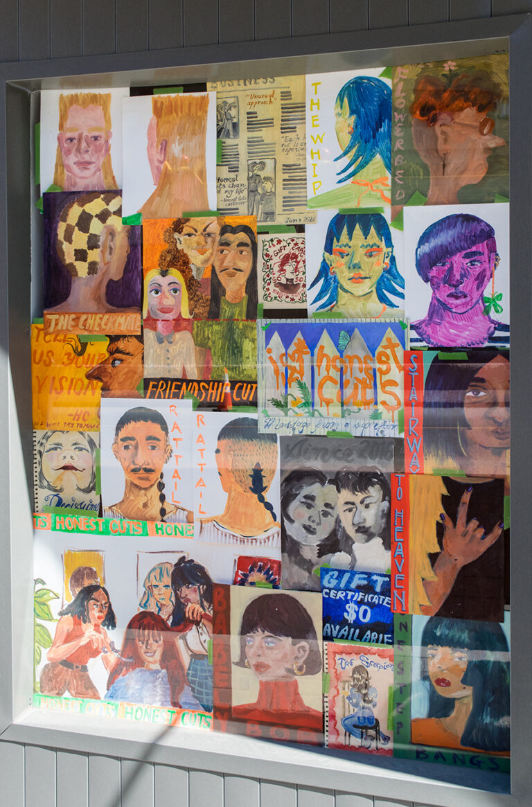 A photo of the front right window of The New Gallery's storefront, in the window are all of the paintings from the "Honest Cuts" project hung in a collage. 