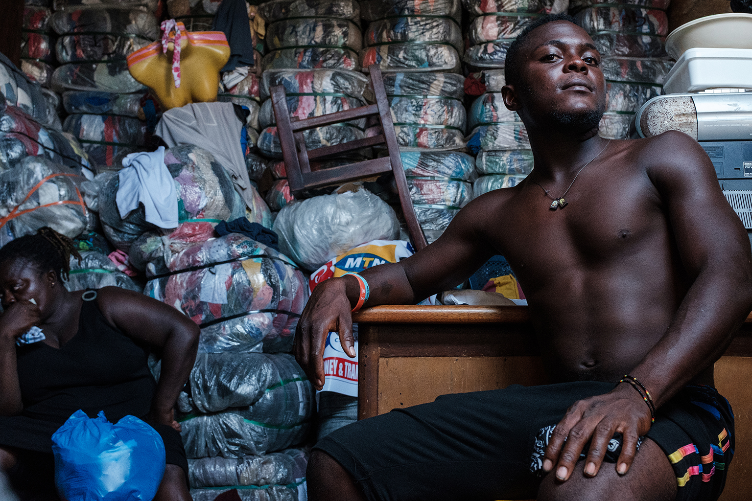 Market seller posing in front of his baled goods, 06.06.2018