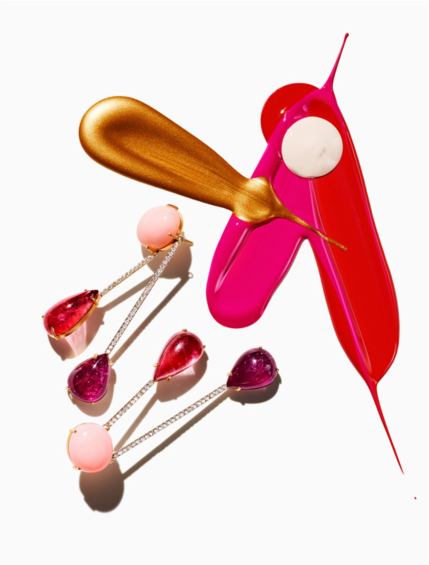KMA stylist Sara Wacksman designs set for abstract photo of pink jewelry and pink paint dripping on white background