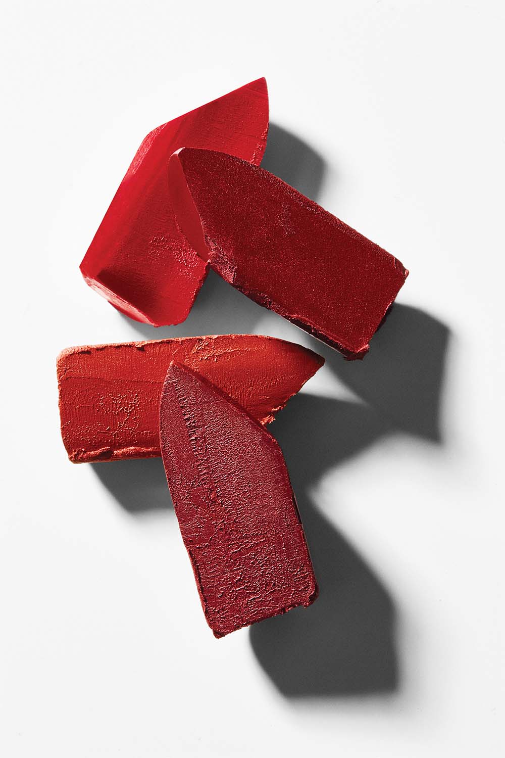 Vibrant red Kjaer Weis lipsticks creatively cut by Texture Stylist Sara Wacksman