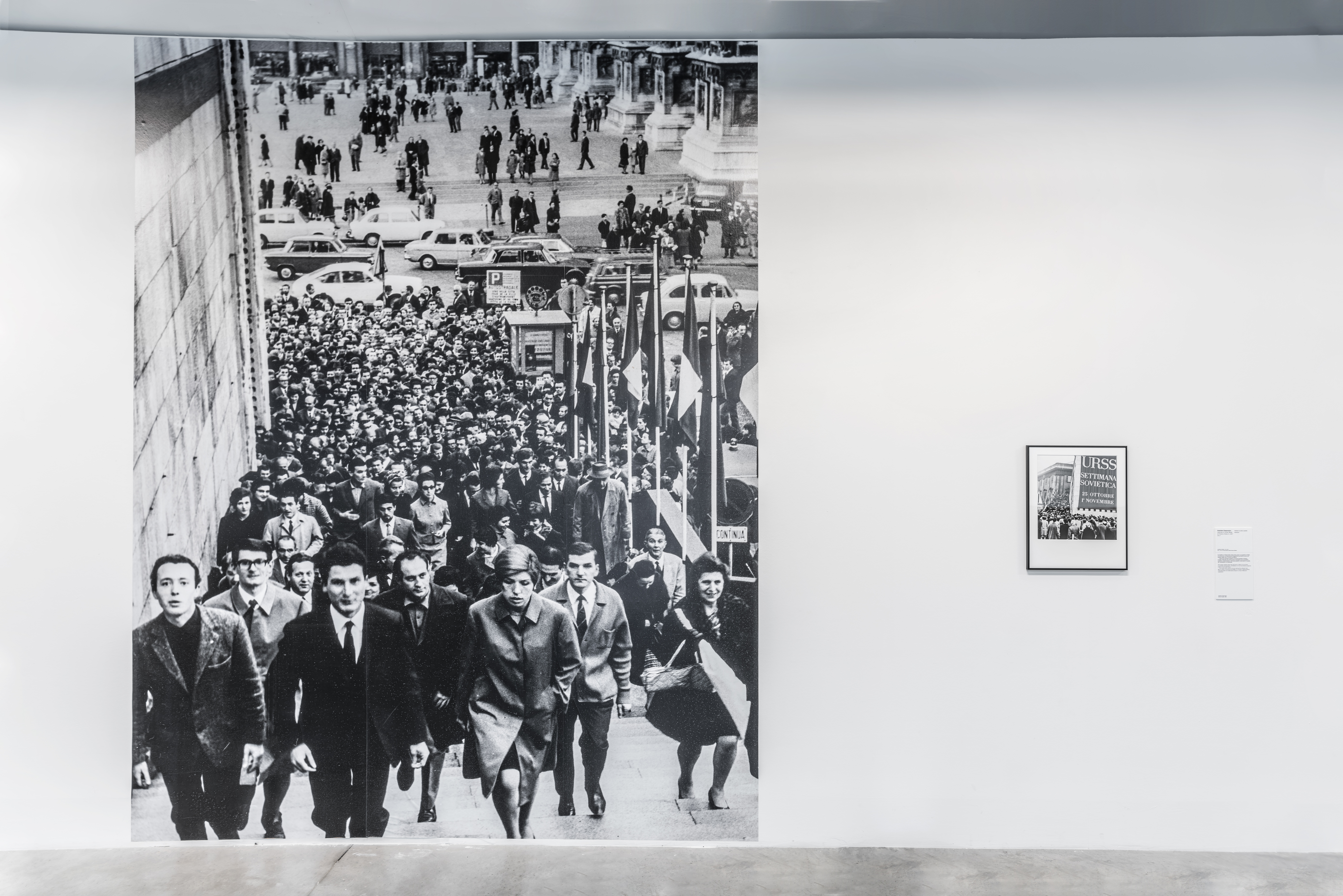 Opening of Soviet Week Exhibition at the Palazzo Reale, Milan, 1967, 2017. Wall-size black-and-white digital print and framed archival pigment print (50×40 cm). Installation view at Centro per l'Arte Contemporanea Luigi Pecci, Prato, 2019. Photo courtesy: Associazione Italia Russia Lombardia, archivio fotografico. Courtesy: the artist.  Photo: Ela Bialkowska