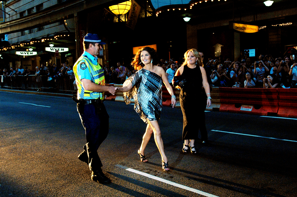  Catherine Zeta-Jones shakes a police officers hand at the premiere of her new film Death Defying Acts