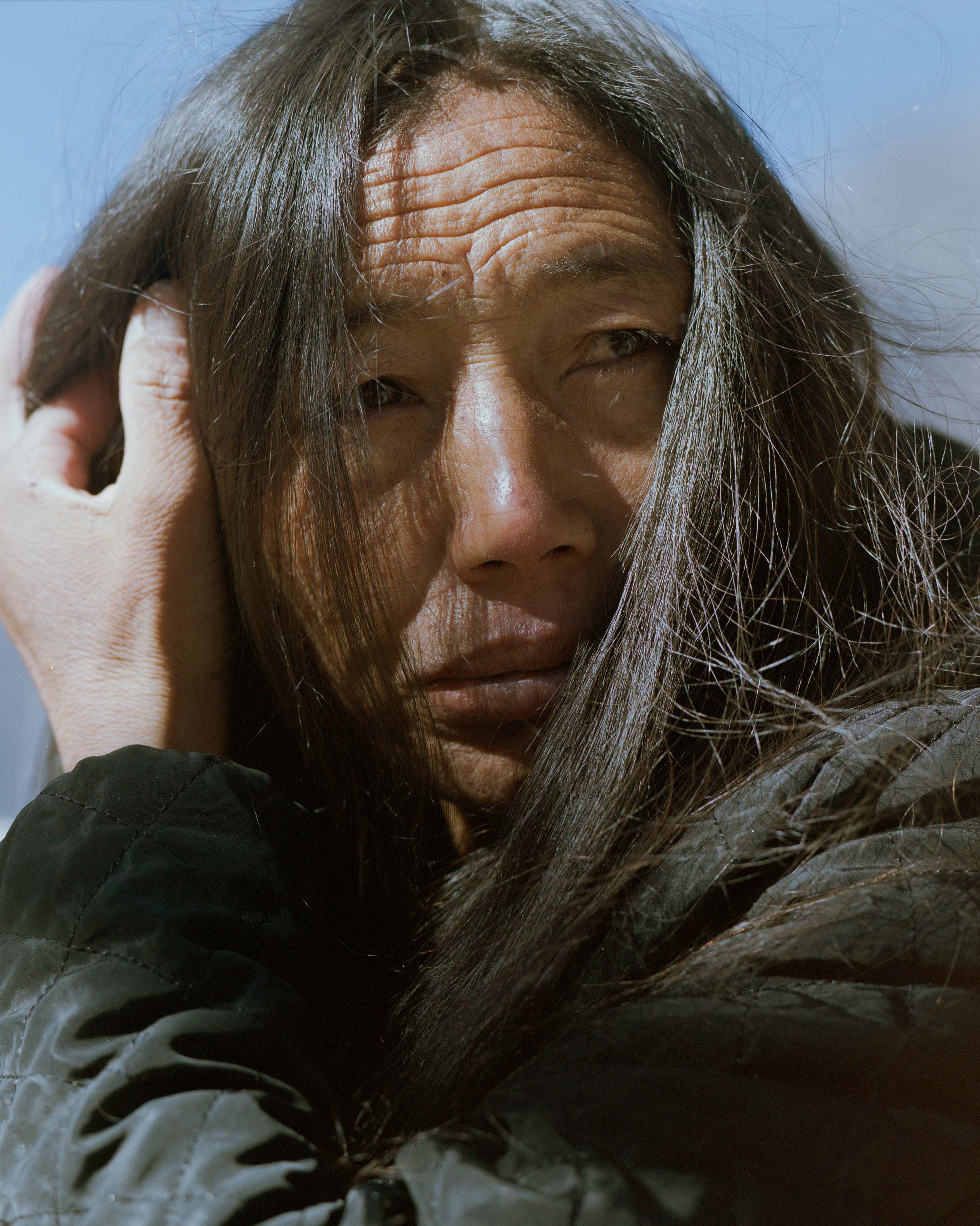 Tsering lost all 23 of her family members during the avalanche. She now lives right next to where the village was, where all her family is still buried underneath the rubble. "I'm close here.." she said and looks up at the peak of Langtang Lirung.  