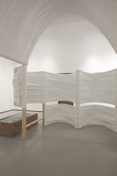 Untitled, 2014, variable size, plaster, burlap, plastic sheets, bricks, plastic emergency water storage bag, water