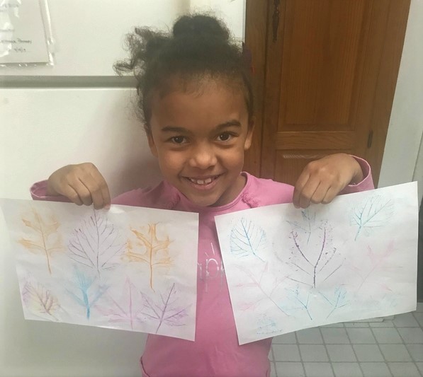 student presenting rubbings