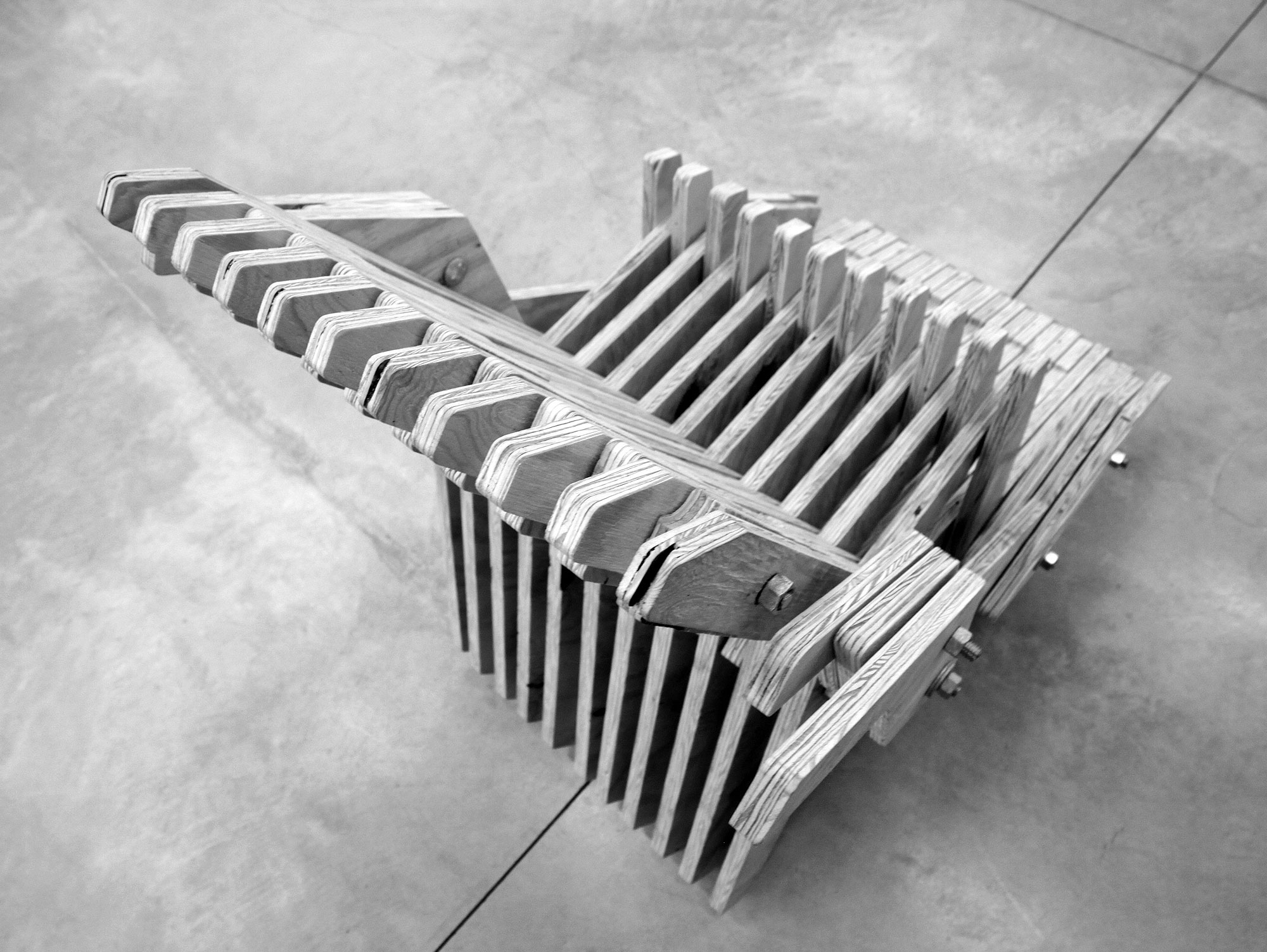 Interlocking wooden slats allow the chair to compress