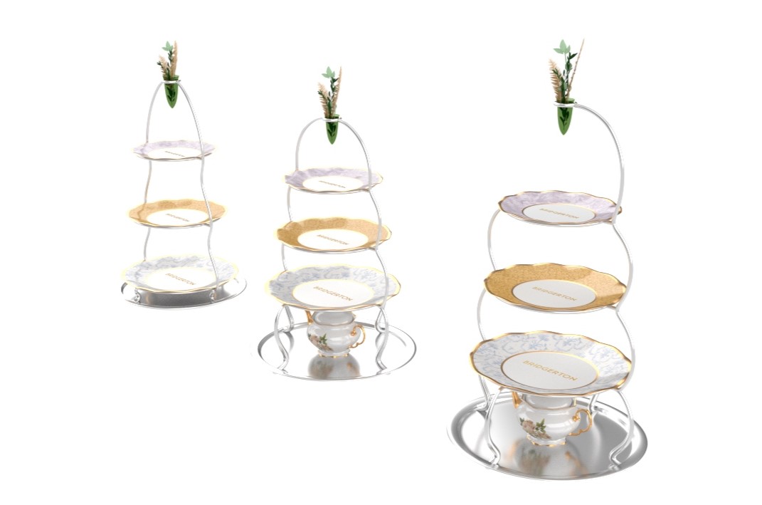 We designed 3 tea tower variations with differing profiles, the plates set into the towers have one each of three “Dine With” family china selections. Flowers are a huge aesthetic component of Bridgerton, so we wanted to make sure to be able to bring flowers to the table in the mounted bud vase - which would act like a handle before being topped with the vase. The variation without the “tea garage” space would come out with a golden tableside cart for extra fanfare.
