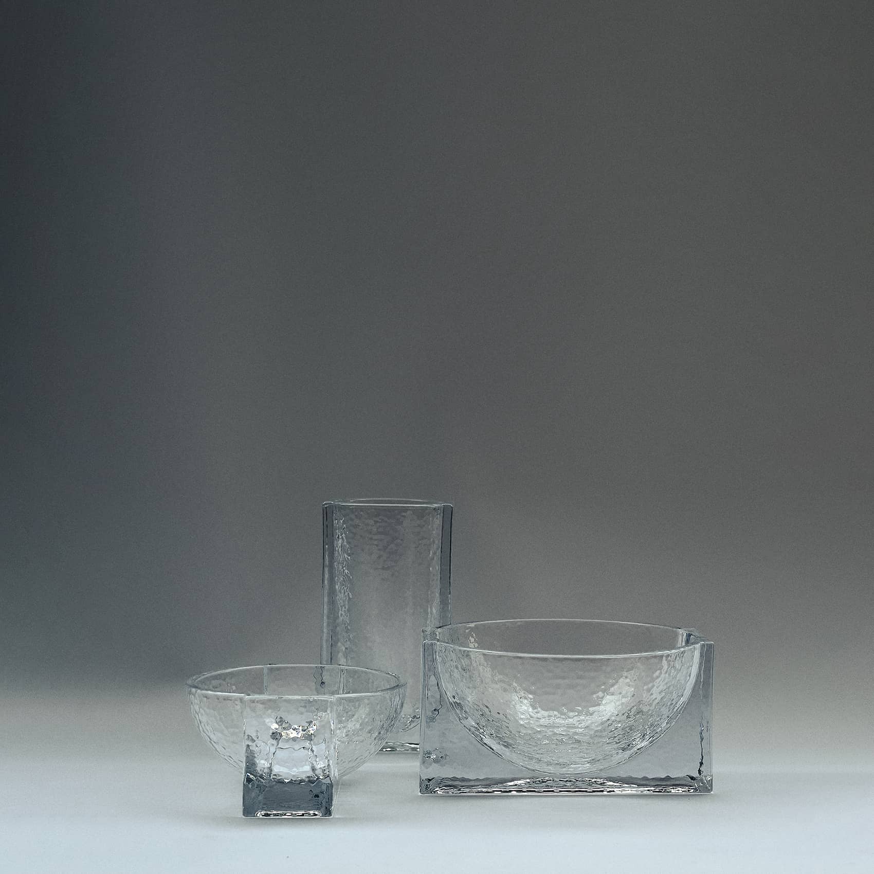 FORMA FOR HOLMEGAARDWith its weighty, sculptural constructions in solid glass, Forma is a product series rooted in the historical Bauhaus era, where shapes like cubes, spheres, and cylinders served as primary design elements. Forma embodies the same graphic strength through massive geometric shapes intersecting with one another. This bold design language engages with the negative space surrounding the structure, influencing how the brain interprets the fusion of forms.Designed in collaboration with Laura BildeGo to product page →