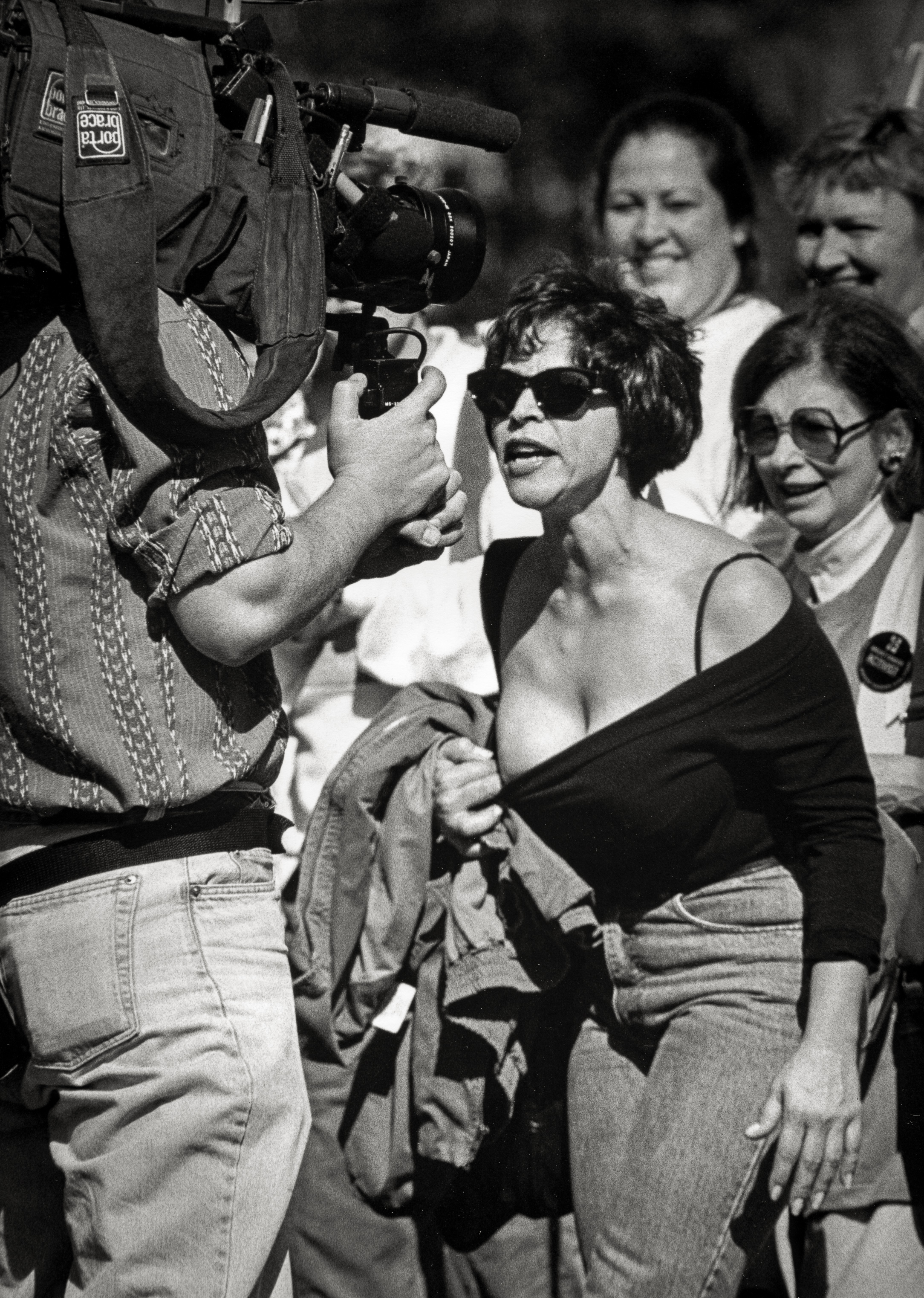 Diane seeks solidarity at a breast cancer march in Washington DC. Women in pink shirts are laughing, smiling, feeling the camaraderie of survivors with a shared history and purpose.She feels no connection with them. She expected tears, shouting, but sees none of the anger she feels. In frustration, she yanks her shirt down, revealing her partially reconstructed chest to a cameraman. "We don't want to see that," he says. "I know you don't want to see it," she screams, "that's why you have to see it."