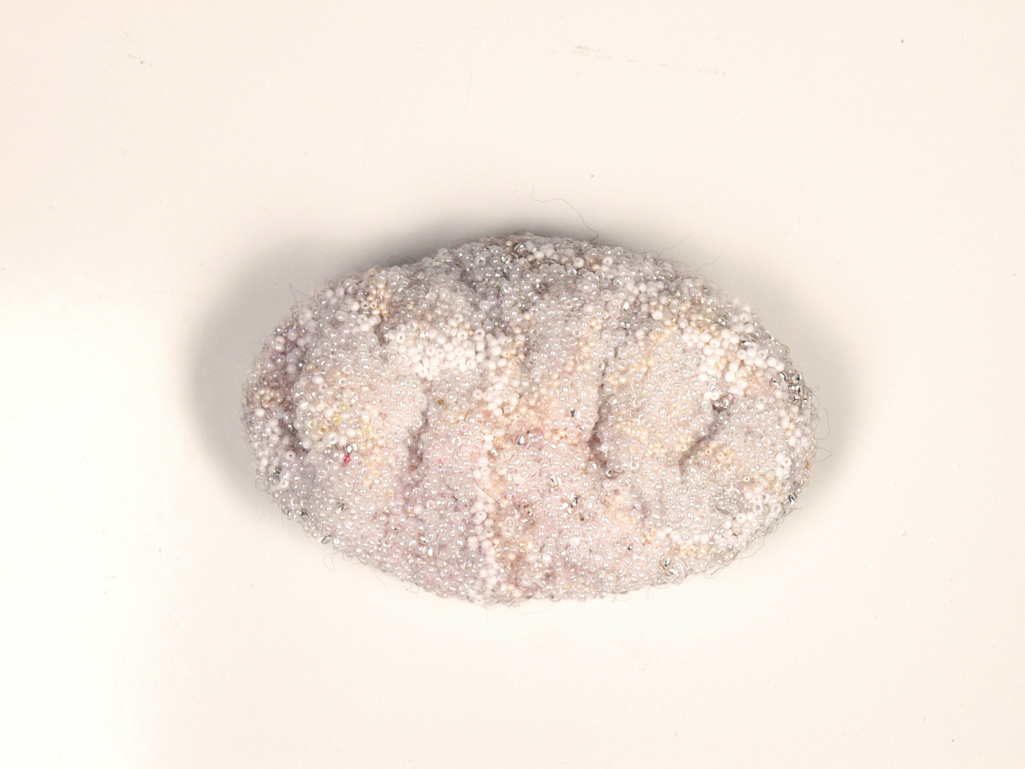  Brancos, 2002/2003 . Hand made felt, hair, fragments of silk and cotton embroidered with glass beads . 13 cm 