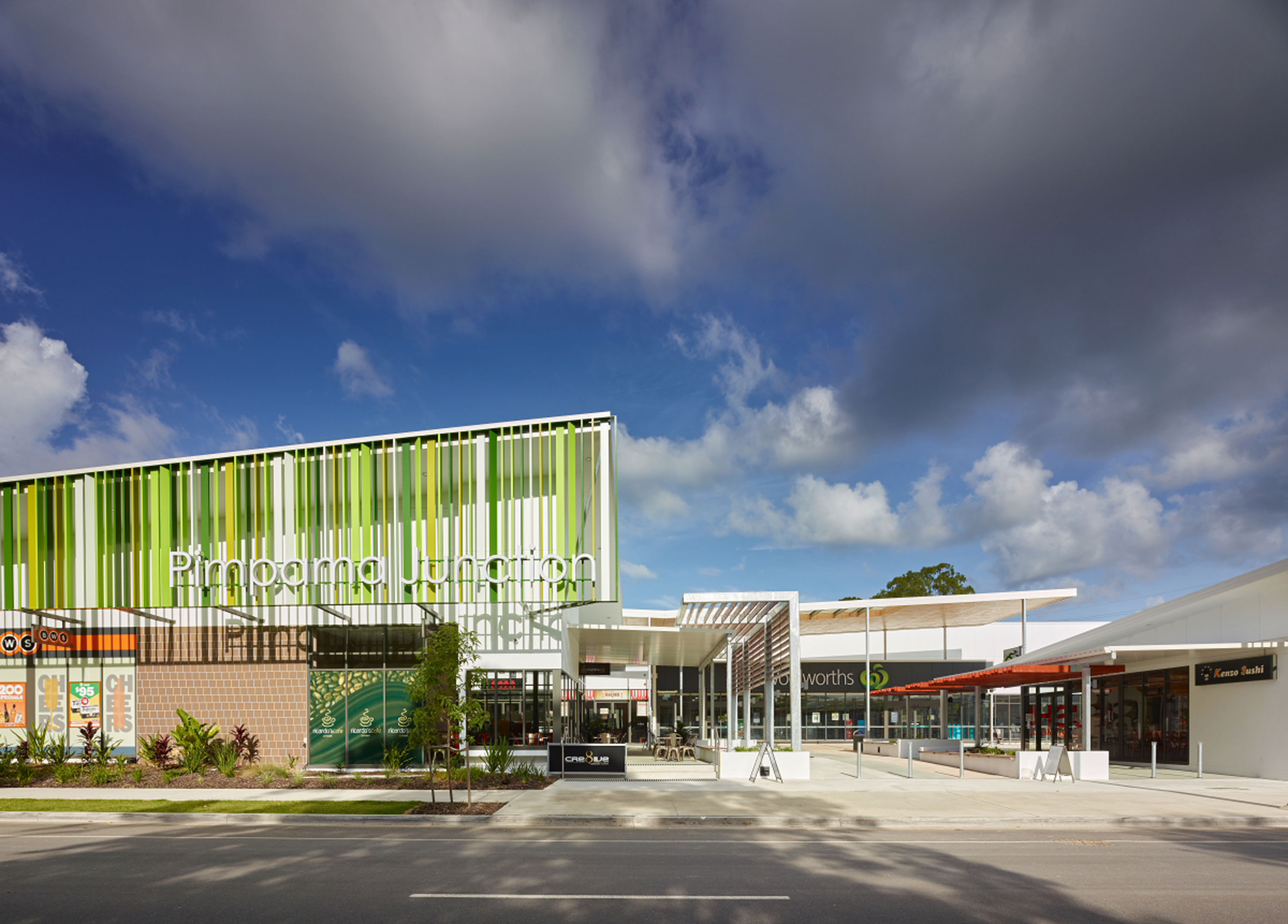 A building with a vibrant green and white striped facade, showcasing a unique architectural design.