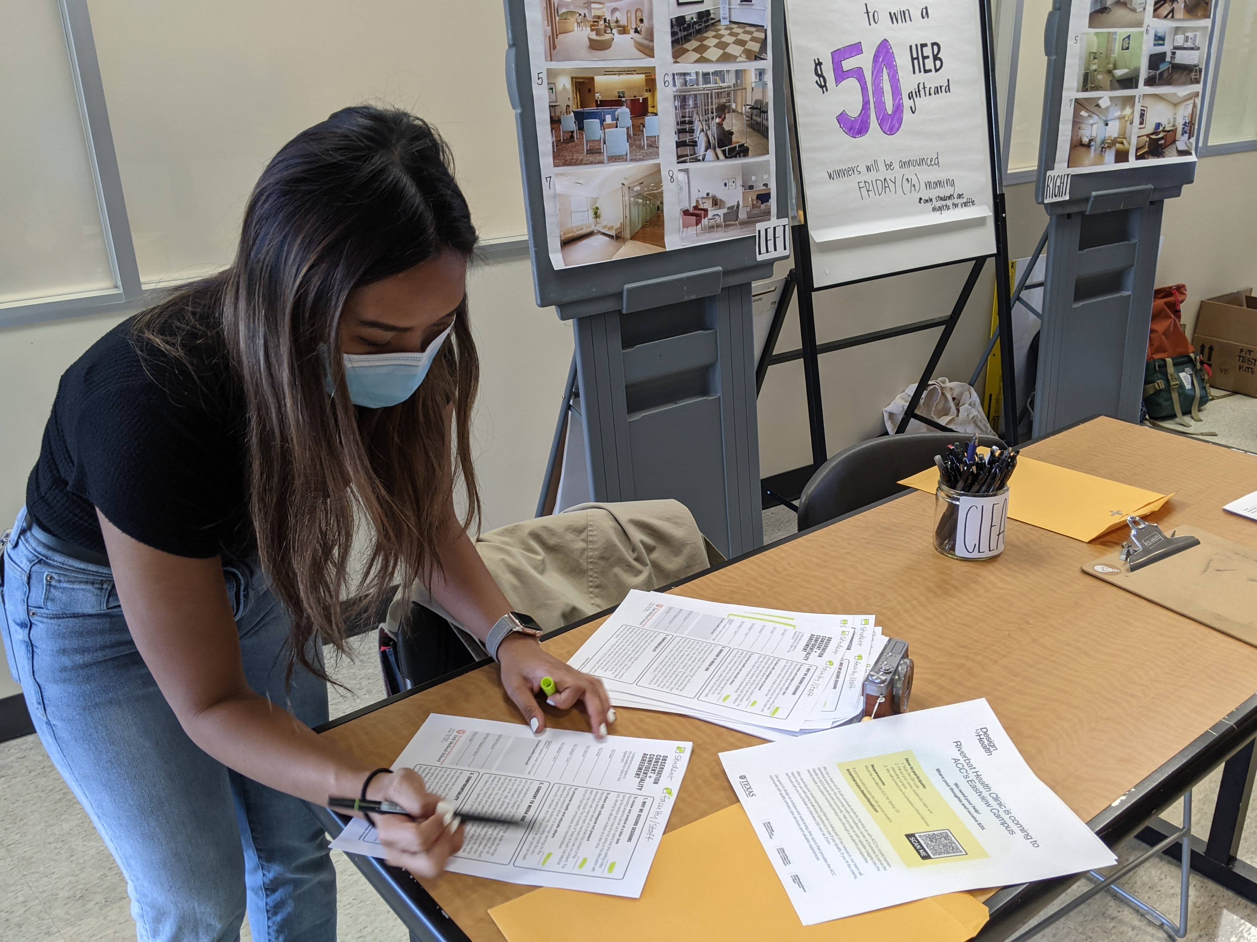 Krezia setting out consent forms and fliers