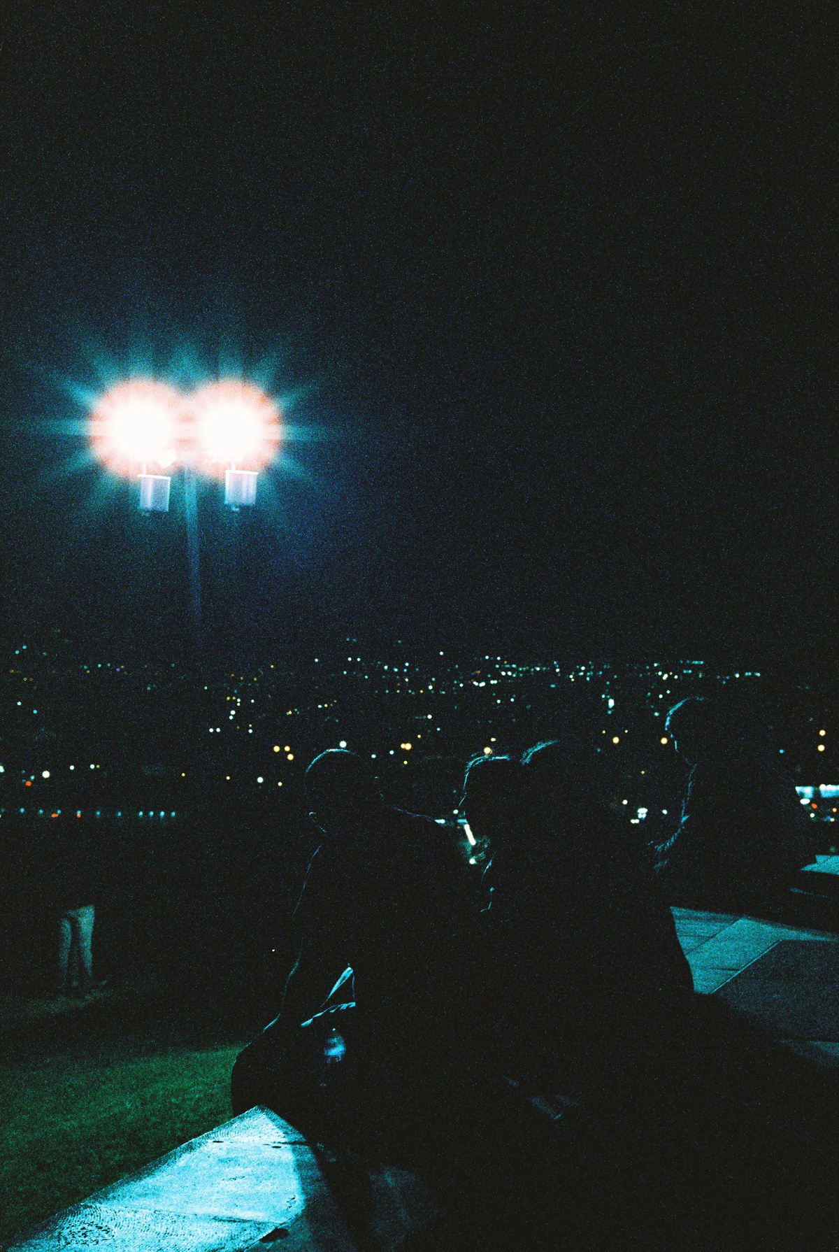 A few college-aged kids, exhausted after marching from central Yerevan to the Genocide Memorial. Cinestill 800T.