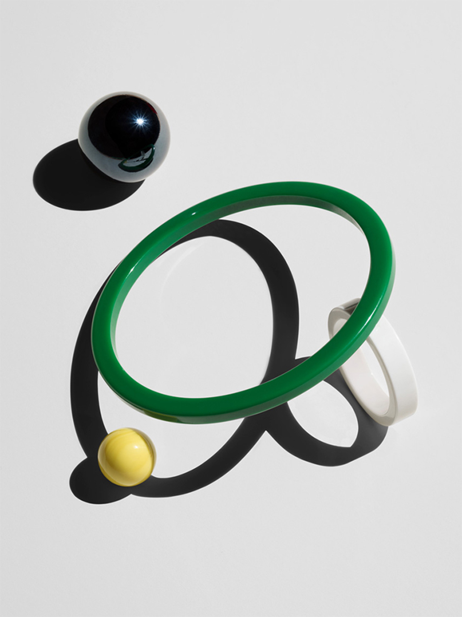 KMA stylist Sara Wacksman designs set for an abstract photo of colorful glass beads and other objects with a white background