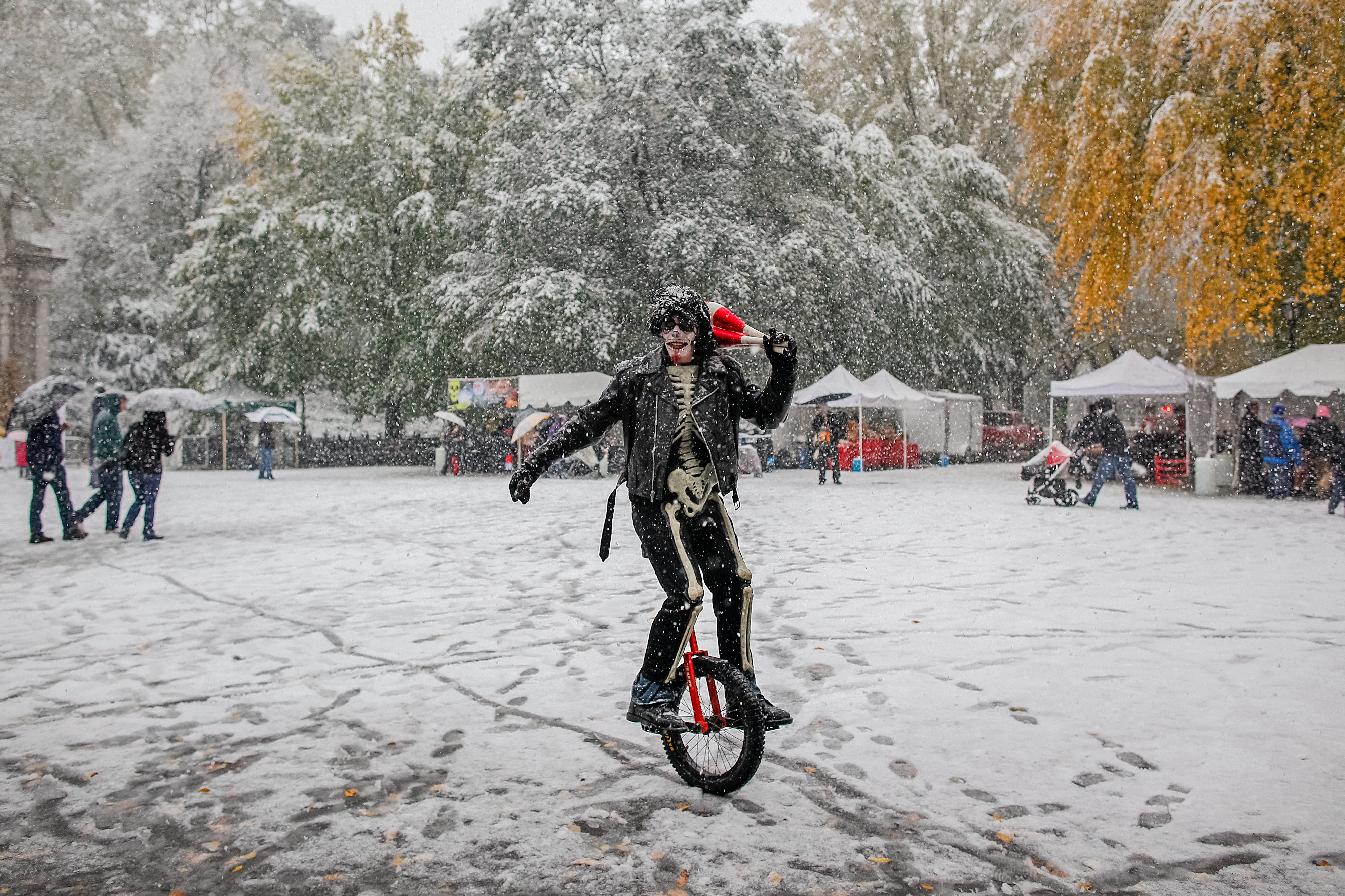 A man unicycles through an October snowstorm near the Naumburg Bandshell in New York’s Central Park. (NYC Tourism + Conventions) 