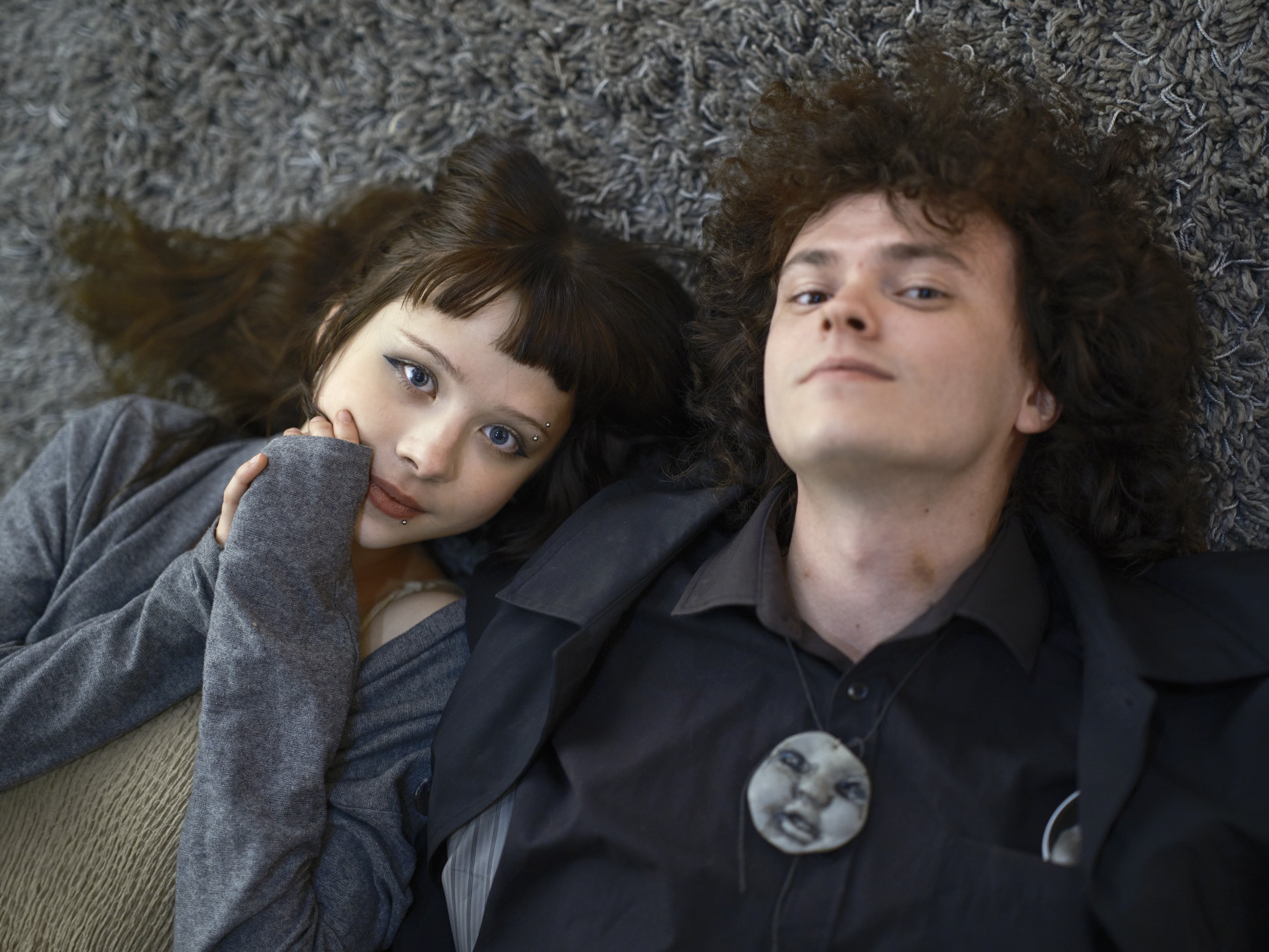 Artist Daria Kolo @blindeslover and Illustrator Roman Yermilov @hornless_faun, wearing a cast around his neck of a doll face left behind in the Chernobyl disaster.