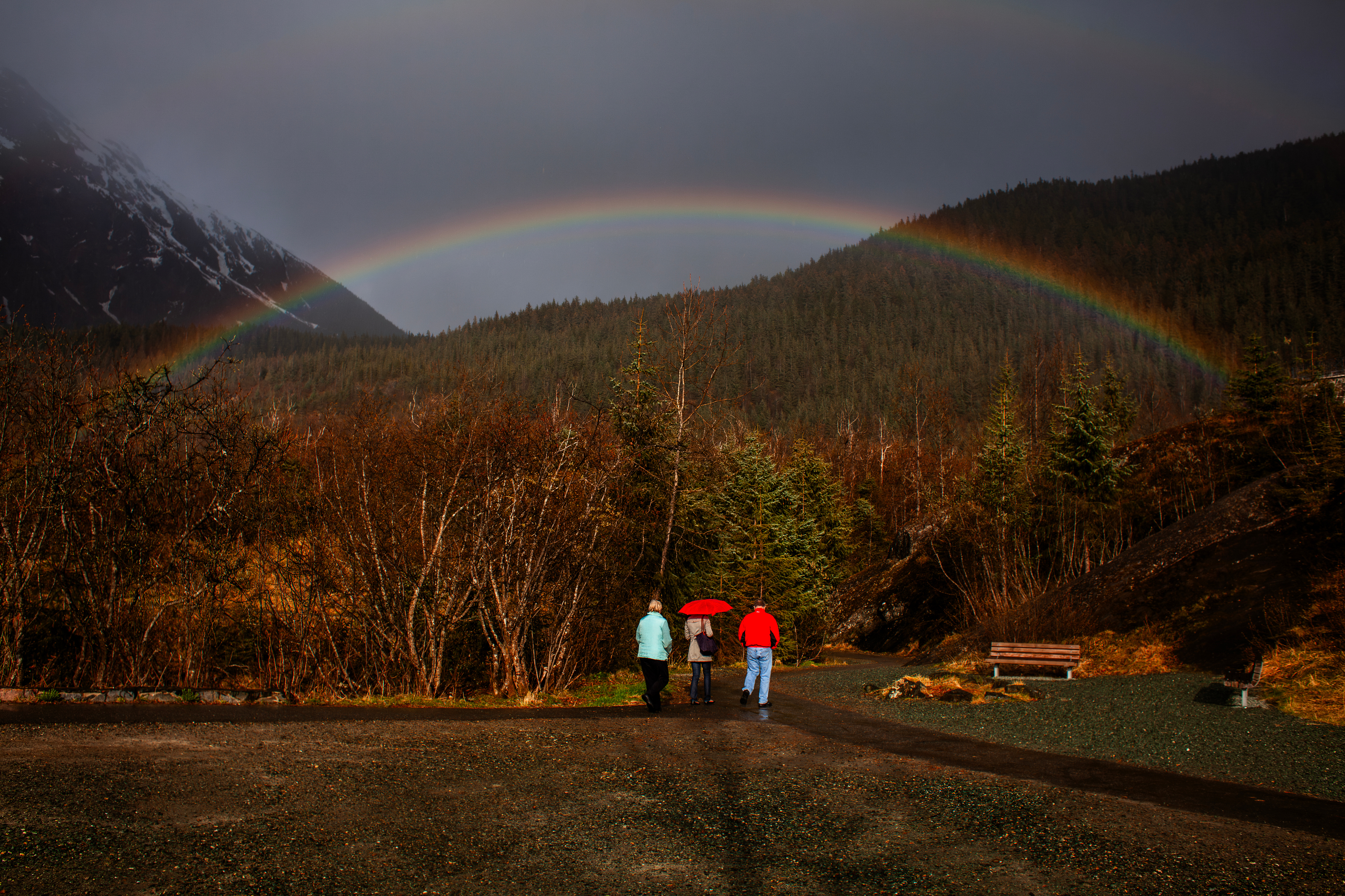 A rainbow appears above tourists in the Tongass National Forest in Juneau, Alaska.