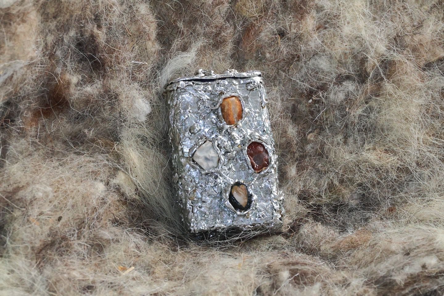Soldered tin with stones from the Suffolk coast. 4 x 7 x 2cm by Lorna Powell