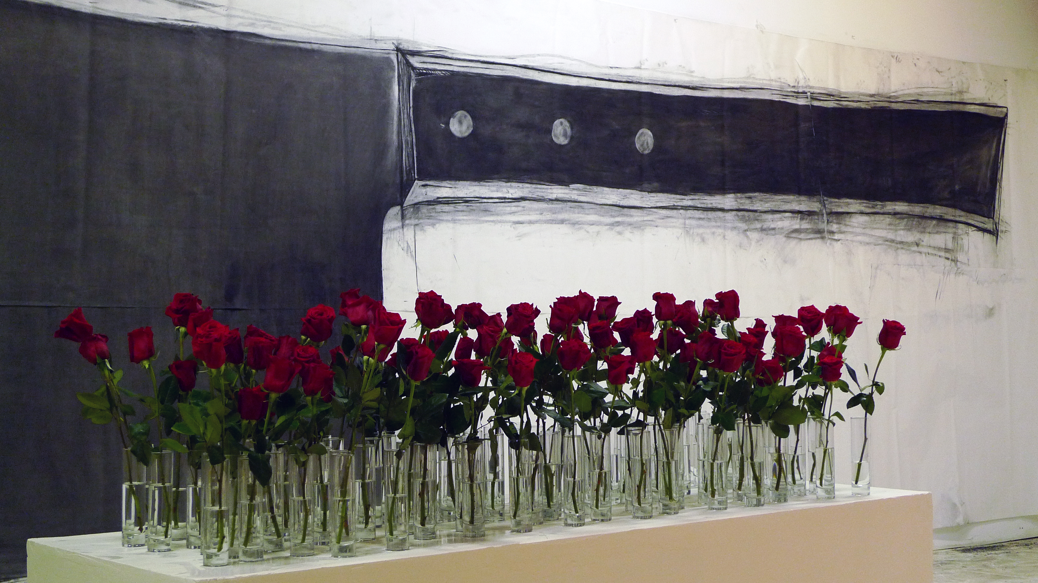 3/3 — BLUE VALENTINE (1,600 ROSES).  Blue Valentine's primary work is an installation of approximately 1,600 live-cut red roses in individual vases. The exact number of roses comes from statistics from the National Violence Policy Center. Their September 15, 2015 report shares that more than 1,600 women are murdered by men in one year in the United States, with 94 percent of women killed by men killed by someone they knew--of the victims who knew their offenders, sixty-two percent were wives or other intimate acquaintances of their killers. Different varieties of roses will reference the varying percentages of these statistics. The project's title Blue Valentine references the 2010 romantic drama of the same name. Studio sketch (100 roses).