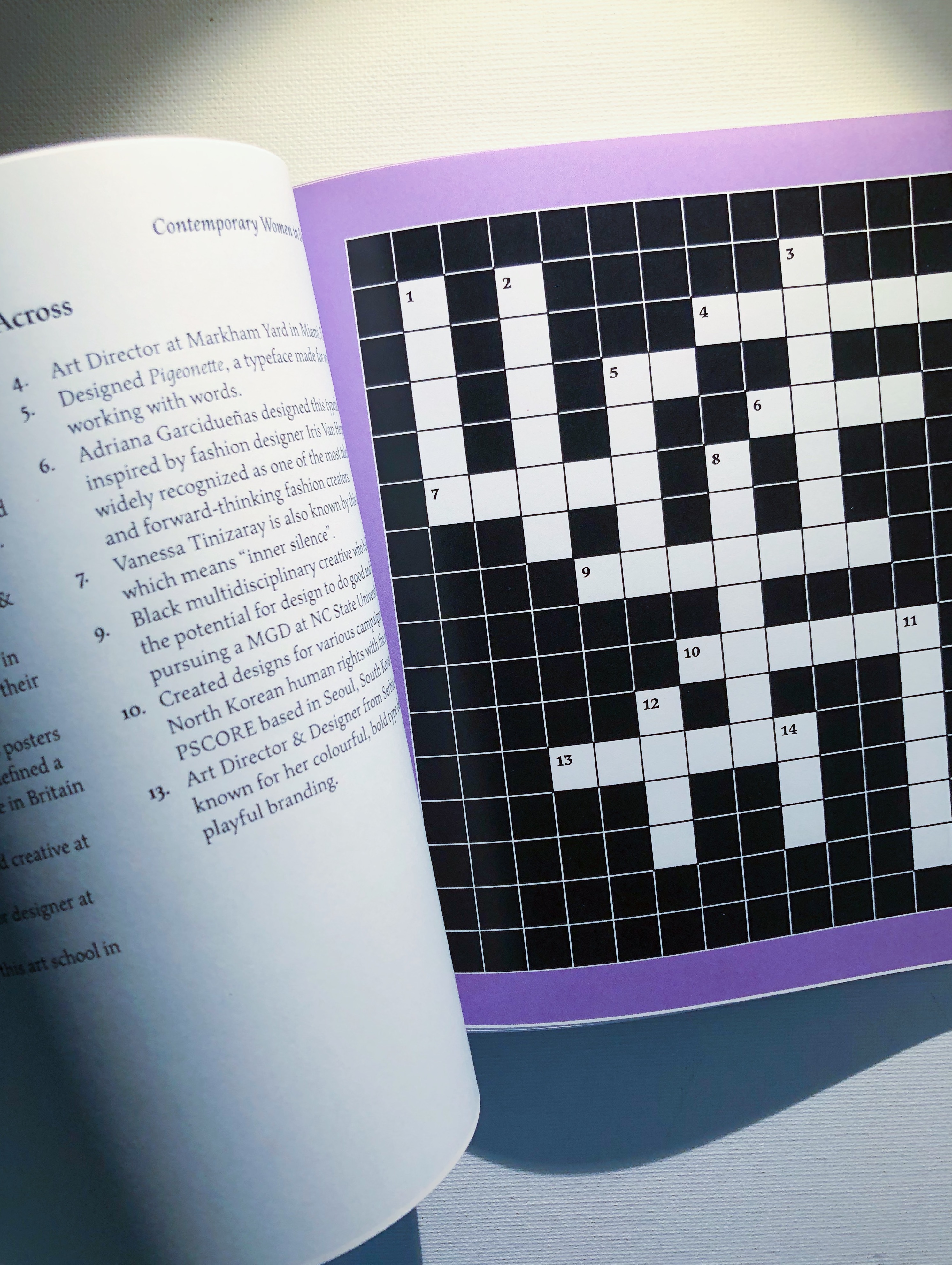 Spread includes content on left side accompanied by crossword puzzle on the right.