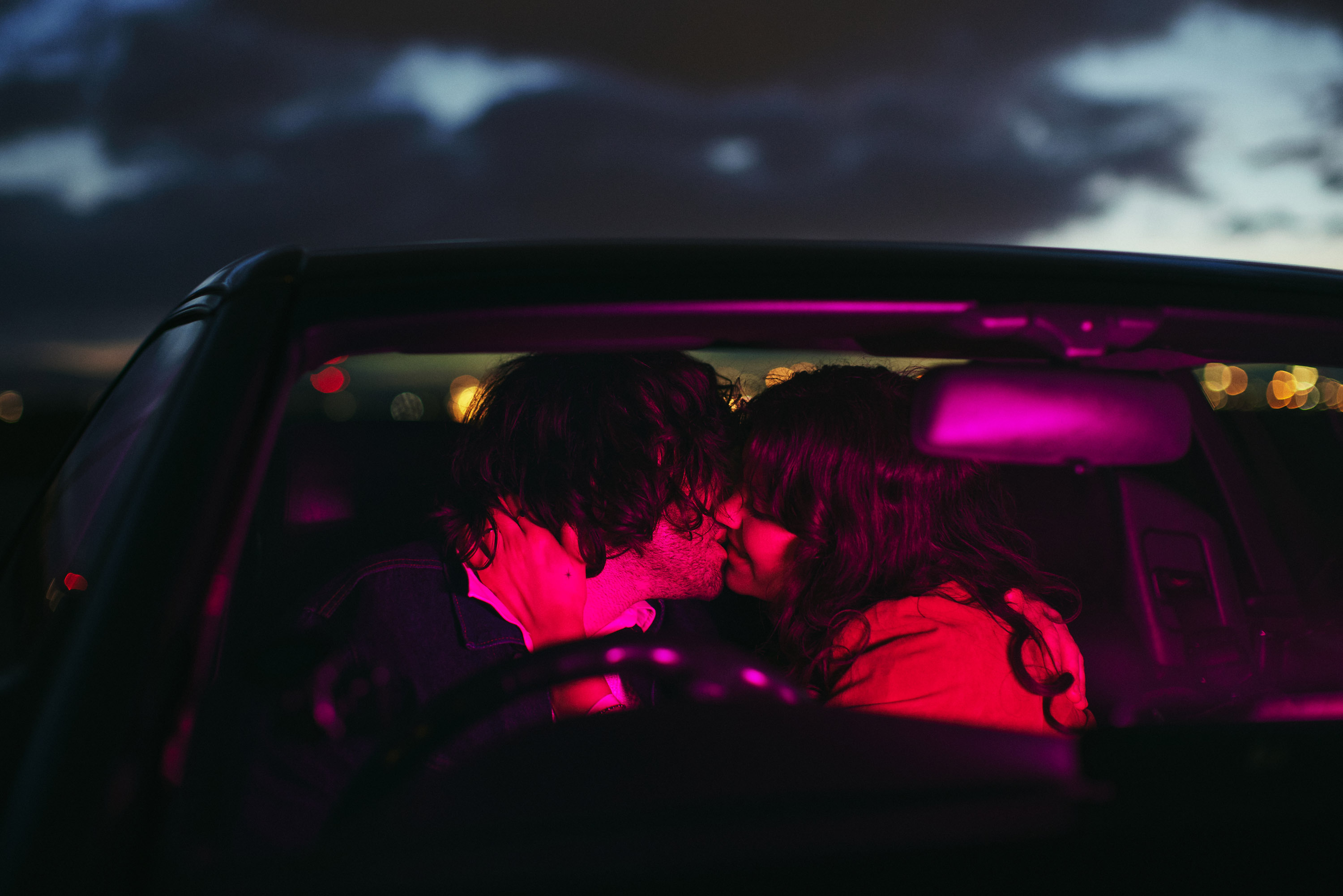 A story of young love in the suburbs told through photography, featuring stylish models in vintage clothing, photographed at sunset in Dublin, Ireland by fashion and lifestyle photographer Alex Sheridan. Suburban Love photo series. Featuring a vintage 1993 Mercedes Benz SL class and cinematic lighting and red light. Euphoria inspired photoshoot.