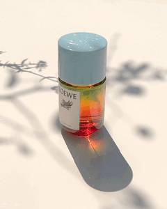 KMA photographer Vincent Gapaillard shoots film of a perfume bottle with a shadow of a branch in the background for Loewe