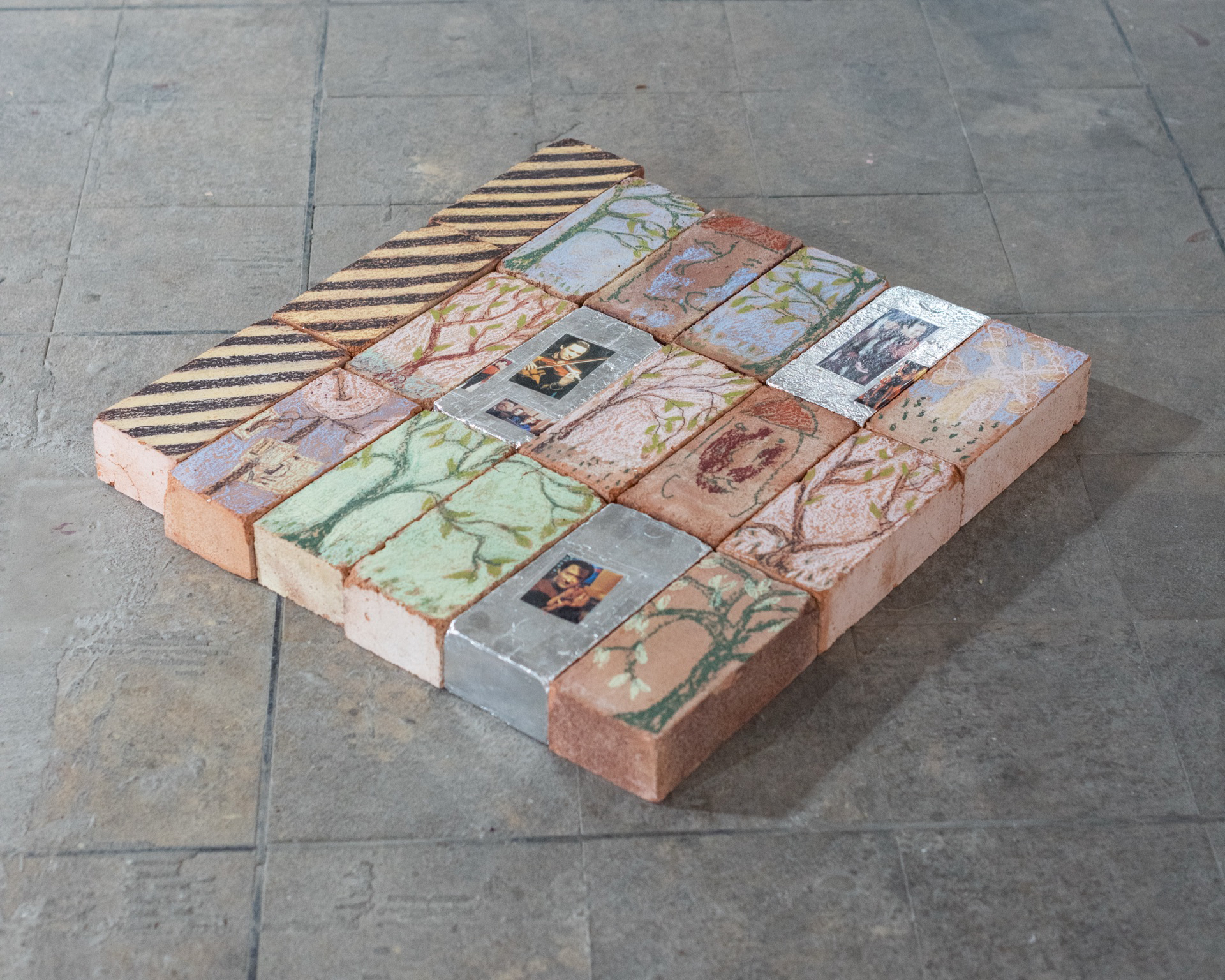 Newton's First Law, 2025, soft pastel, photo-cut-outs, and insulation tape on london commons bricks, 64.5x61.5x6.5cm