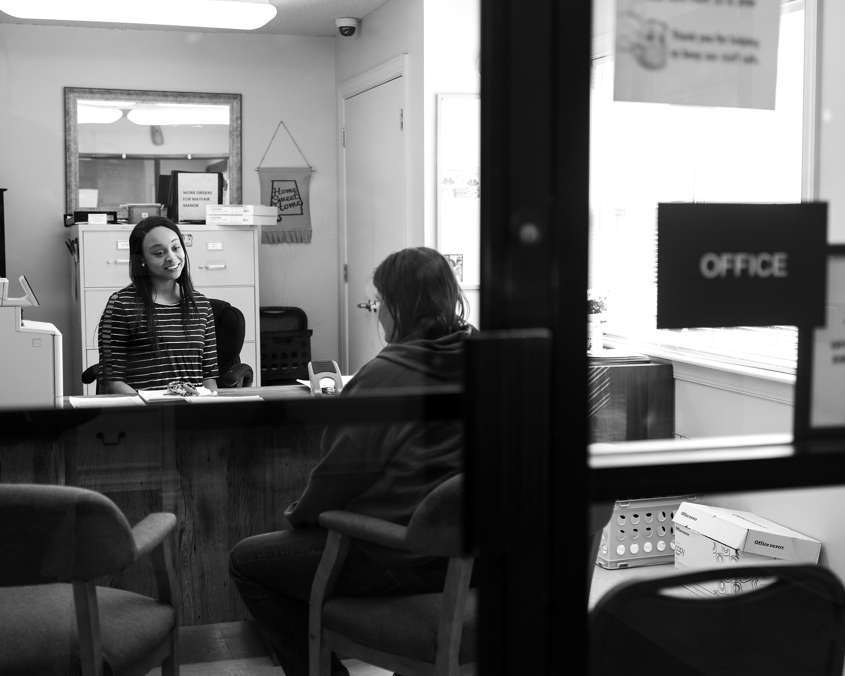 Virettia Whiteside talks with a resident of the Mayfair Apartments.